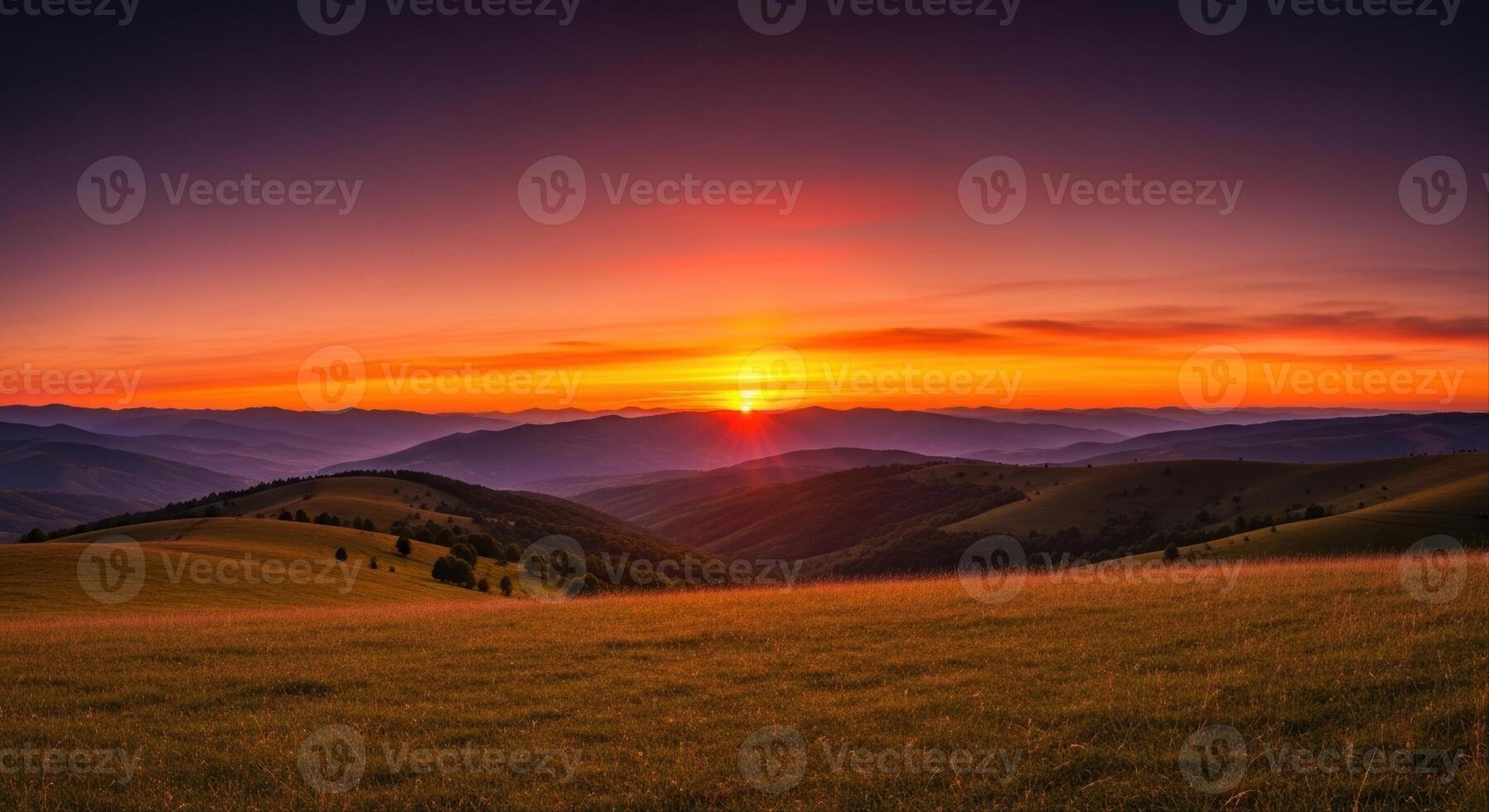 Dramatic sunset over rolling hills and a vast golden field in a serene landscape photo