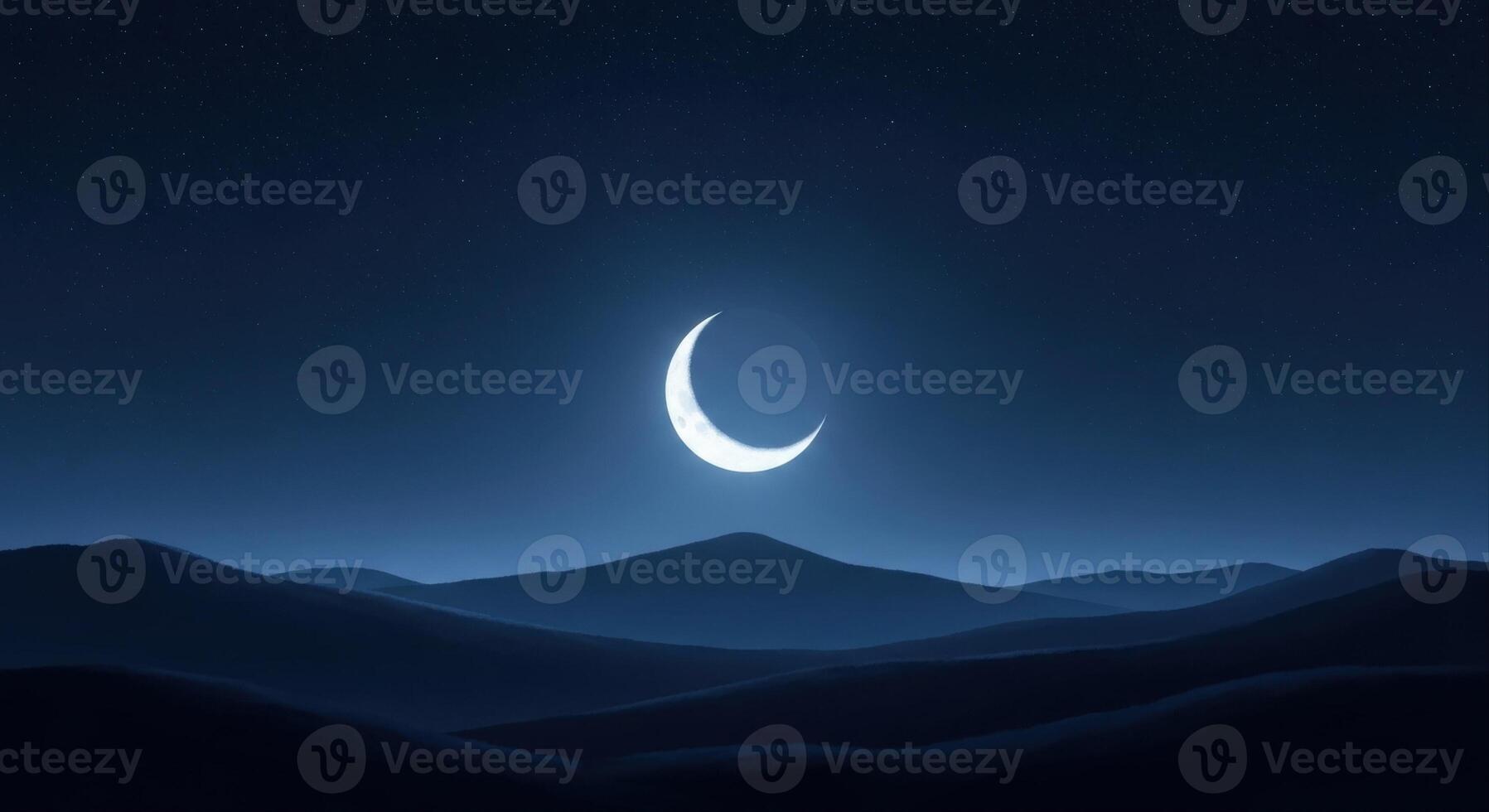 Crescent Moon Shining Brightly Above Dark Rolling Hills in a Serene Night Sky photo