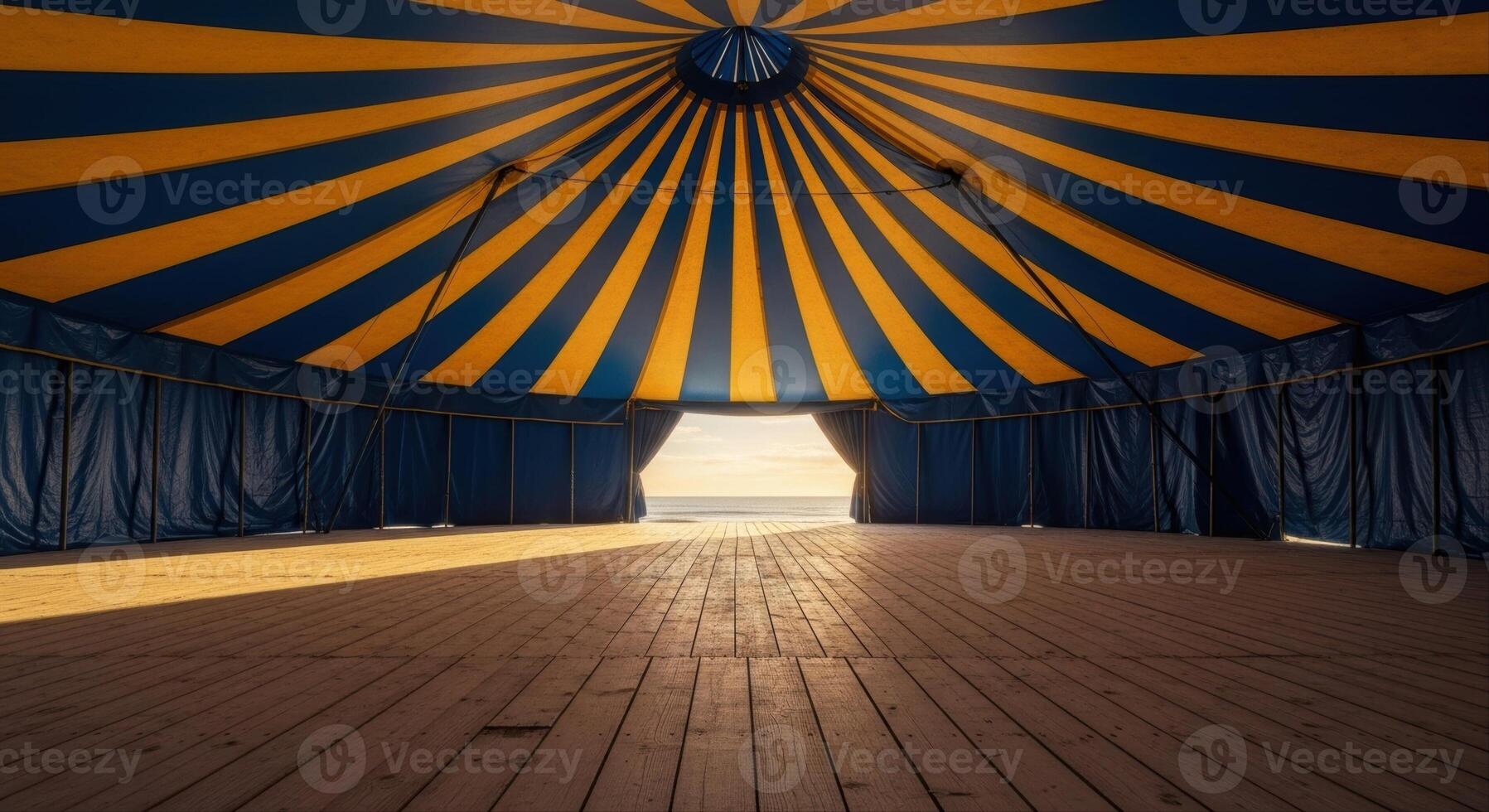 Empty Grand Circus Tent Interior with Blue and Yellow Striped Ceiling and Wooden Floor photo