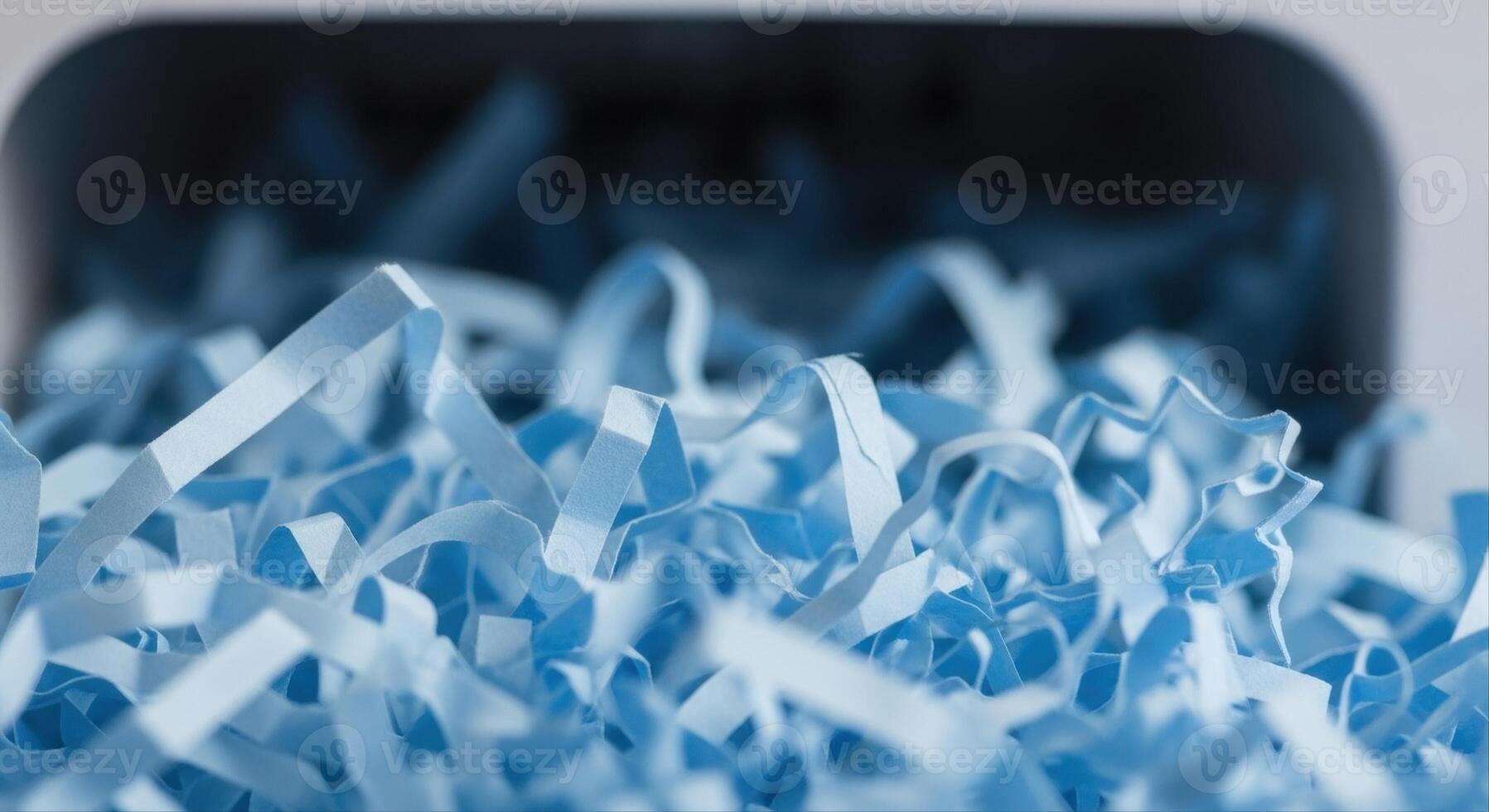 Close up of light blue shredded paper showing thin curled strips and abstract texture photo