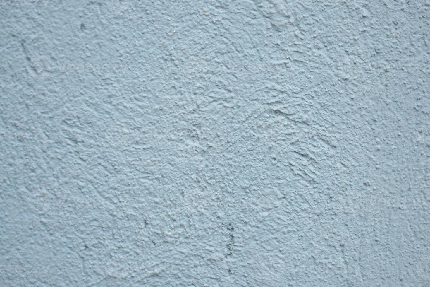 Textured blue wall surface with unique patterns and tones photo