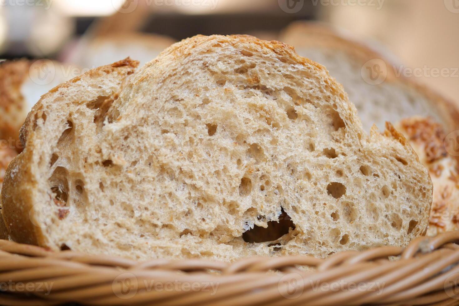 Freshly baked bread slices in a woven basket photo