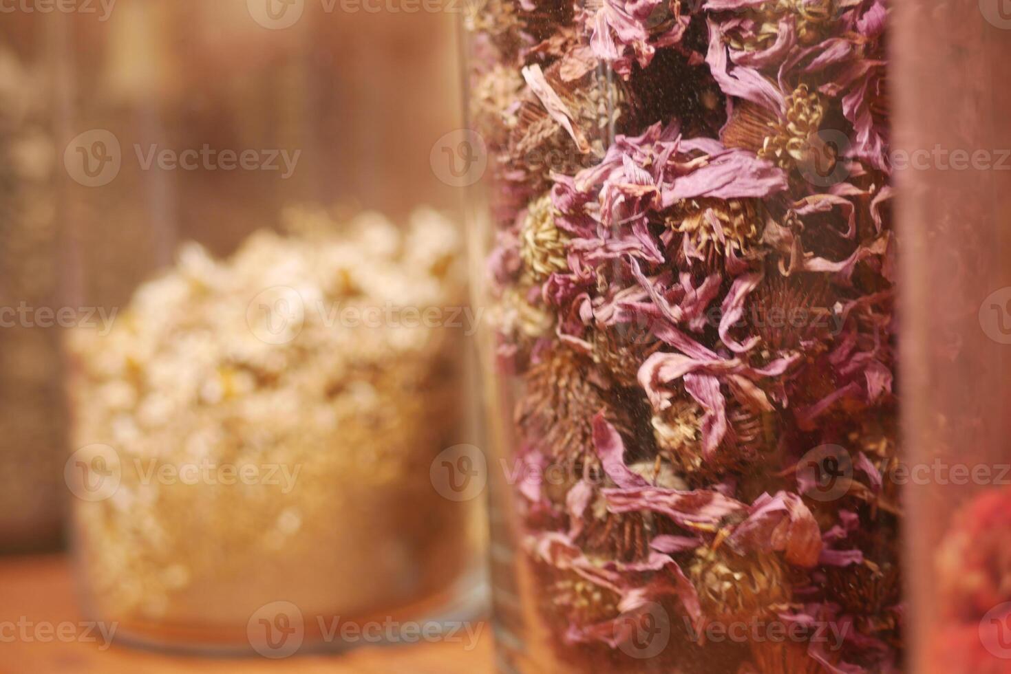 Colorful dried flowers in glass jars for herbal crafts photo