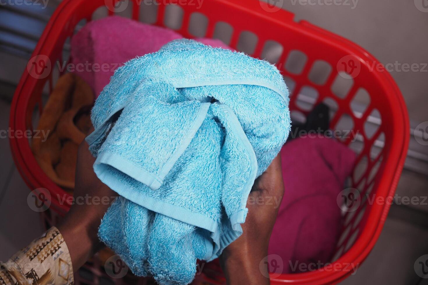 Colorful towels being sorted in laundry basket photo