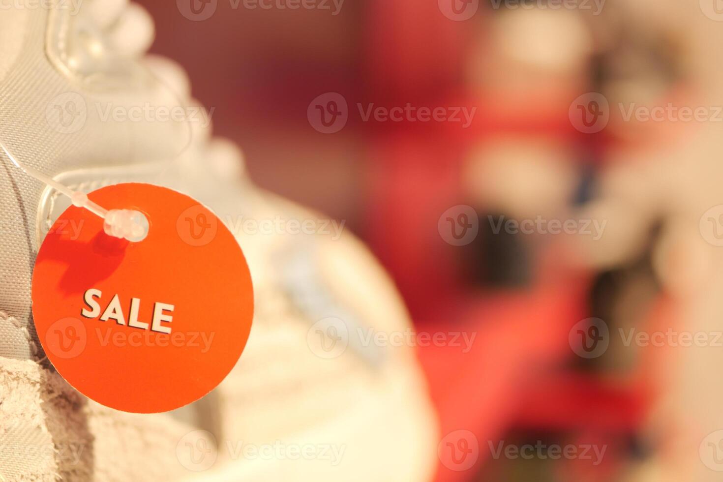 Sale tag on sneaker at retail store display in daytime photo