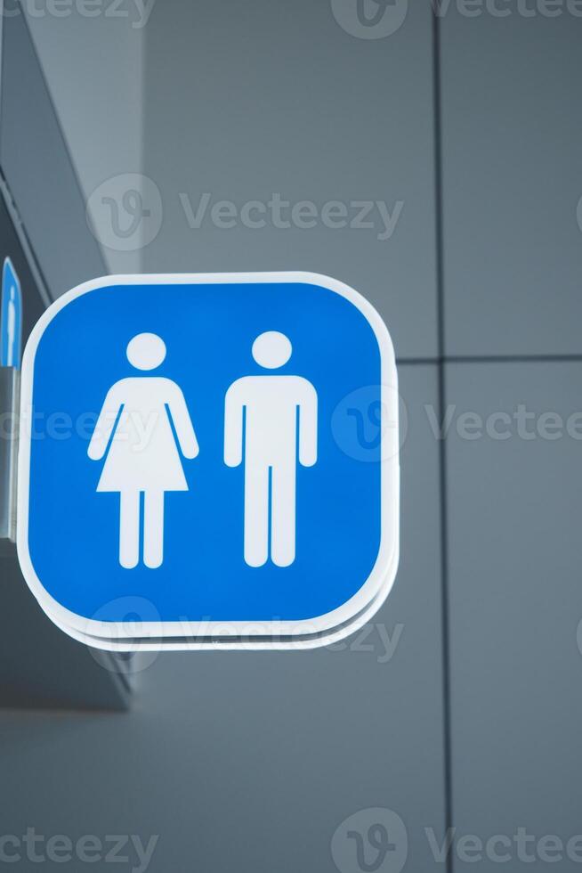 Sign indicating restrooms for men and women in public space photo