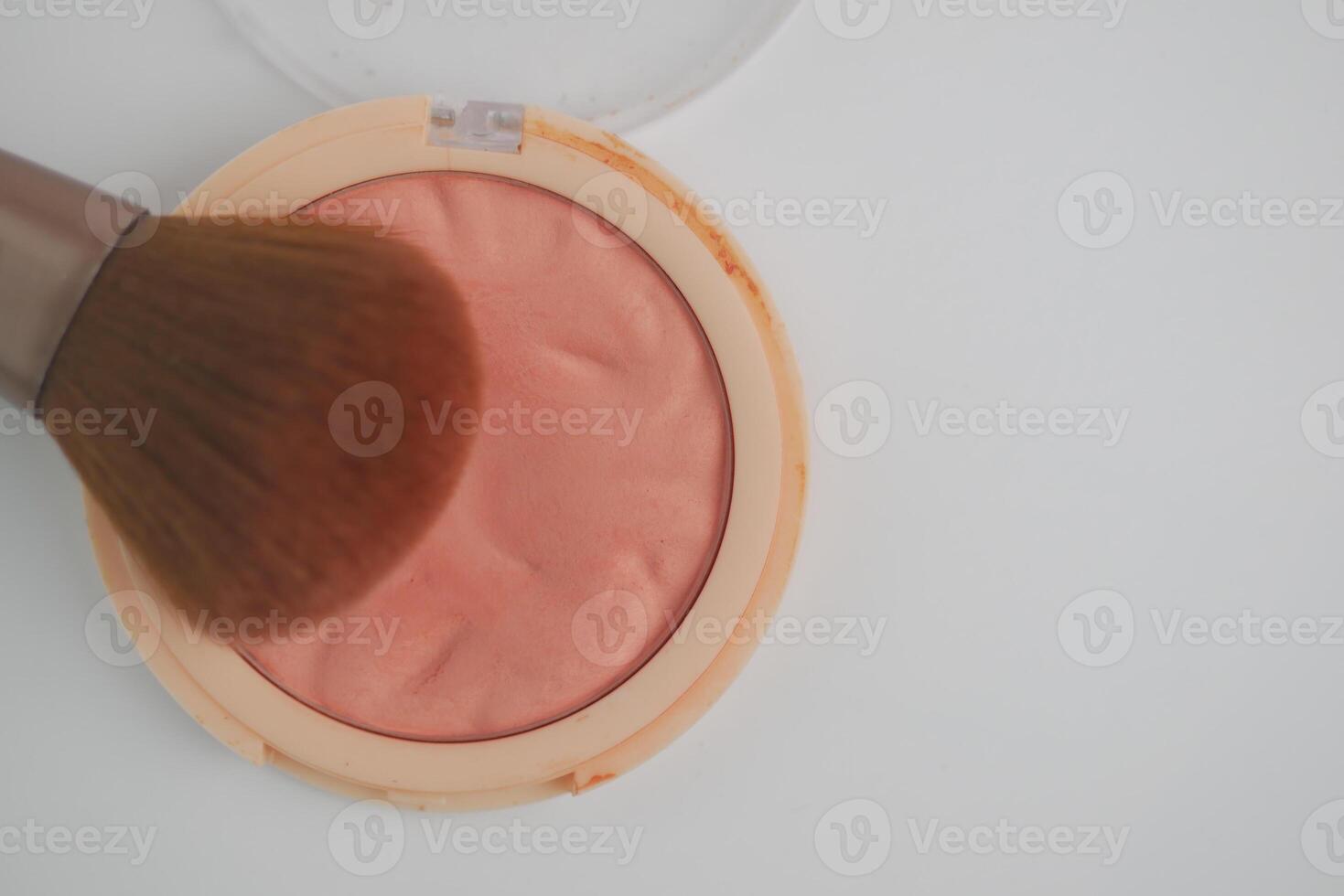 Blush application with brush on a smooth surface photo