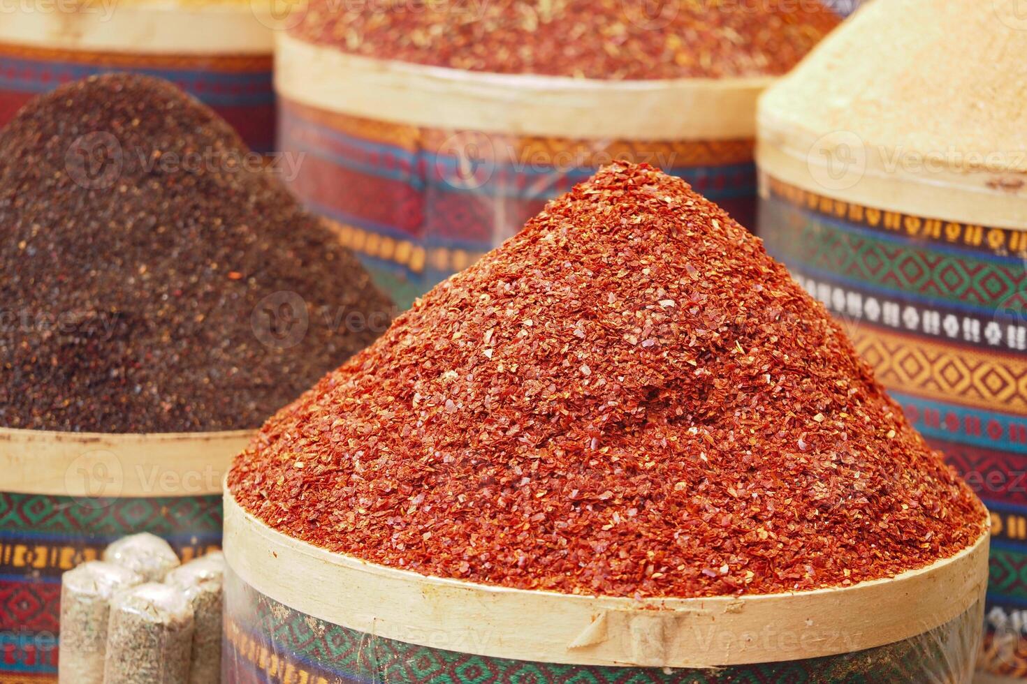 Vibrant spices displayed in a market during daytime photo