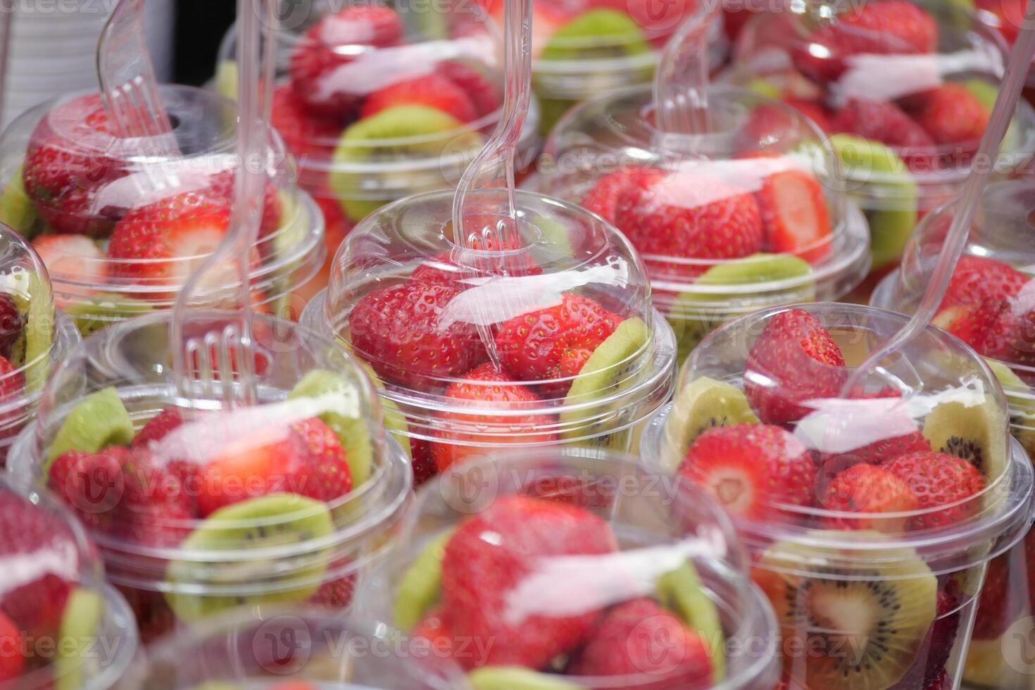 Fresh fruit cups at a market stall in summer photo
