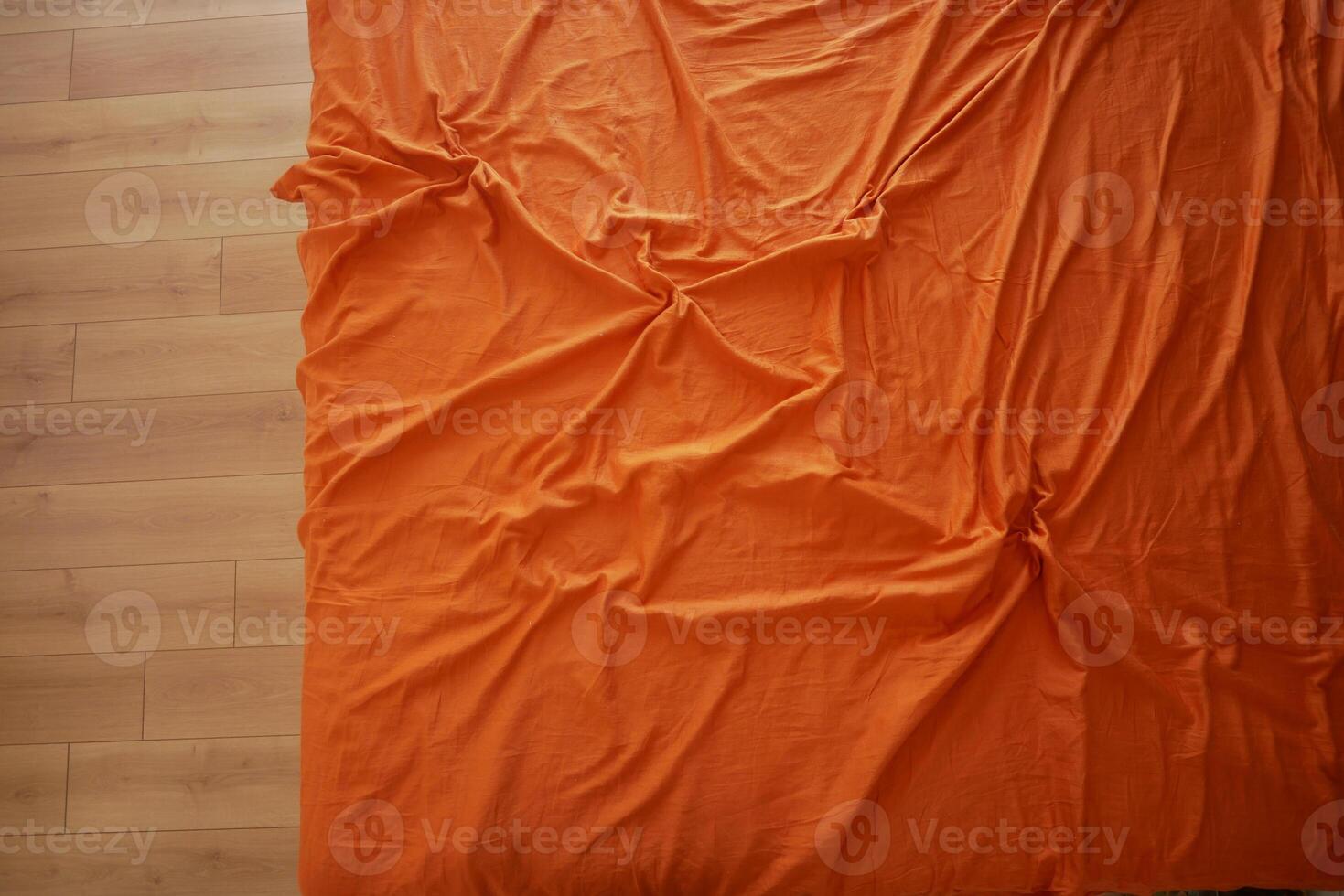 Orange Fabric Background with Natural Wrinkles and Folds photo