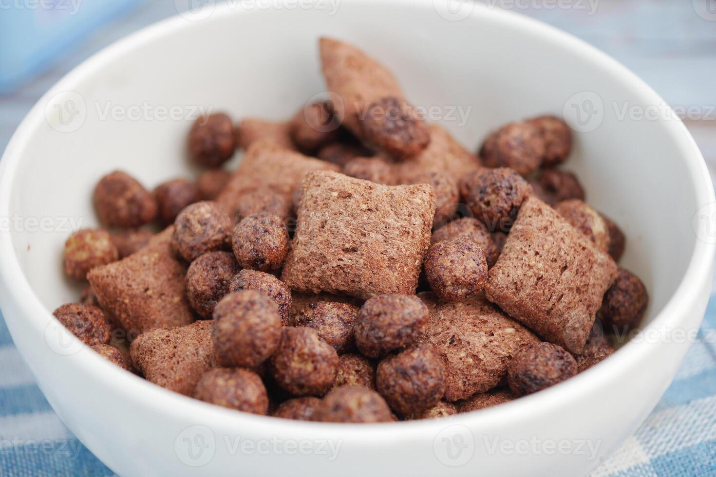 Chocolate cereal bowl filled with crunchy pieces photo