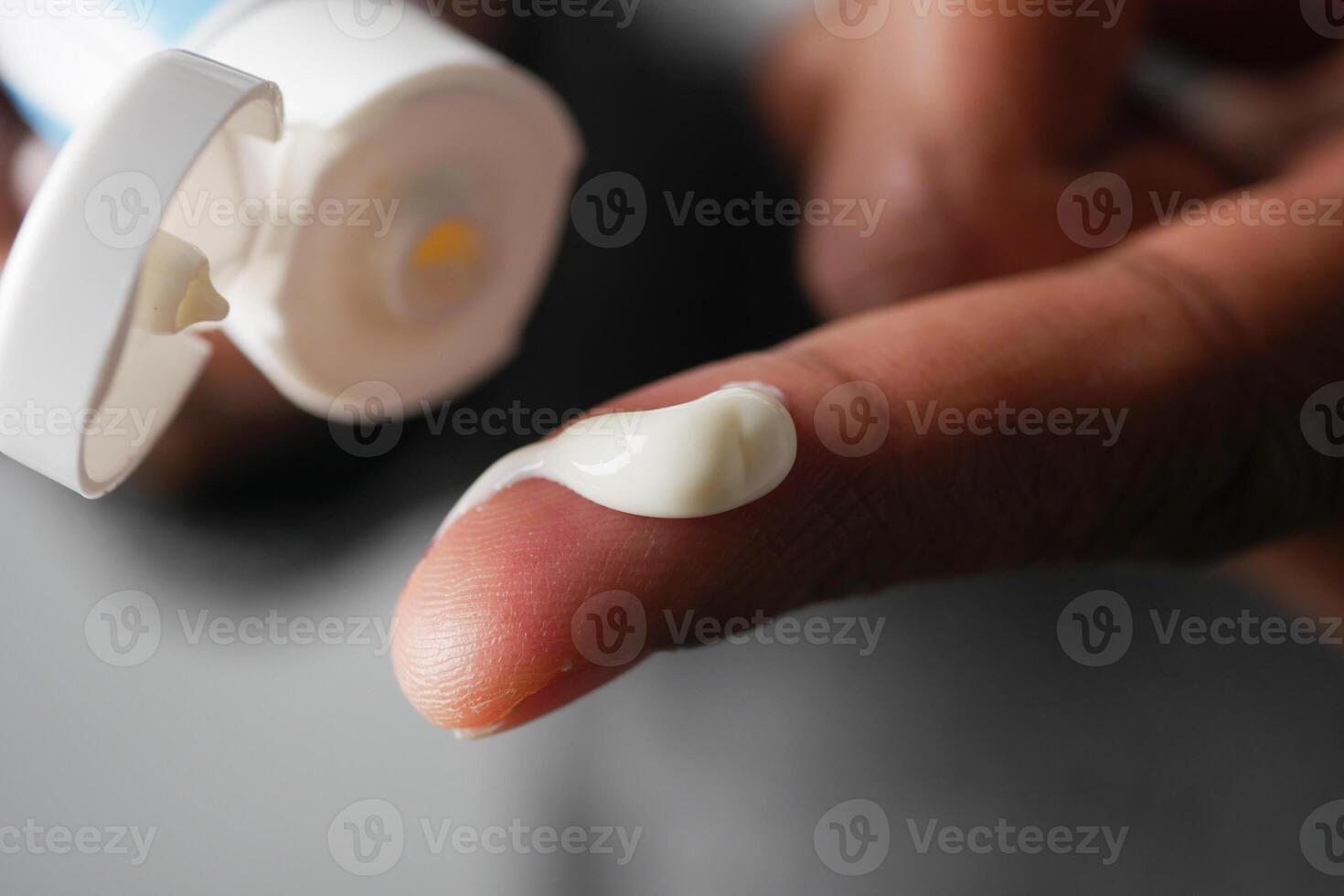 Hand applying moisturizing cream in a close-up view photo