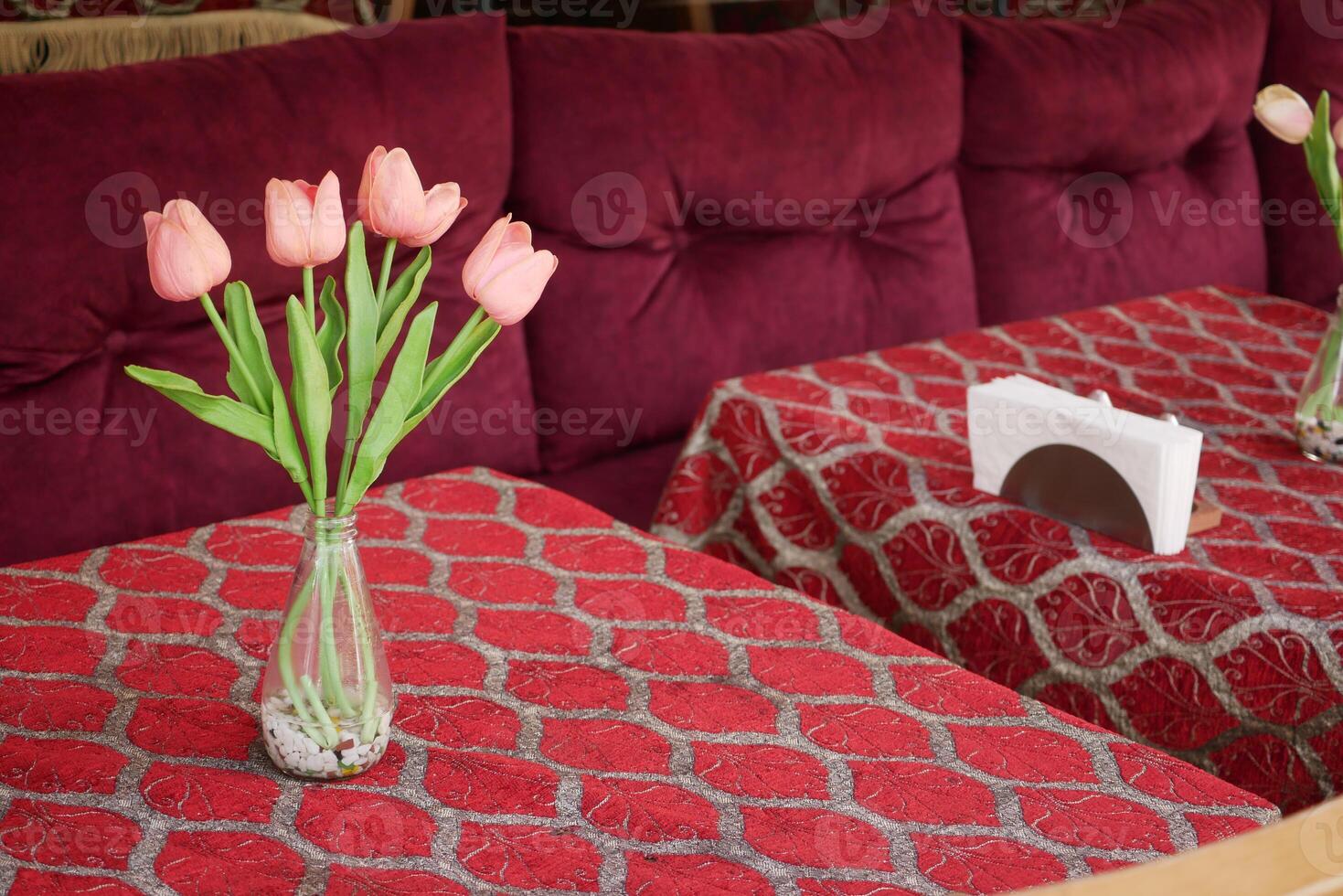 Elegant table setting with tulips and vibrant fabric photo