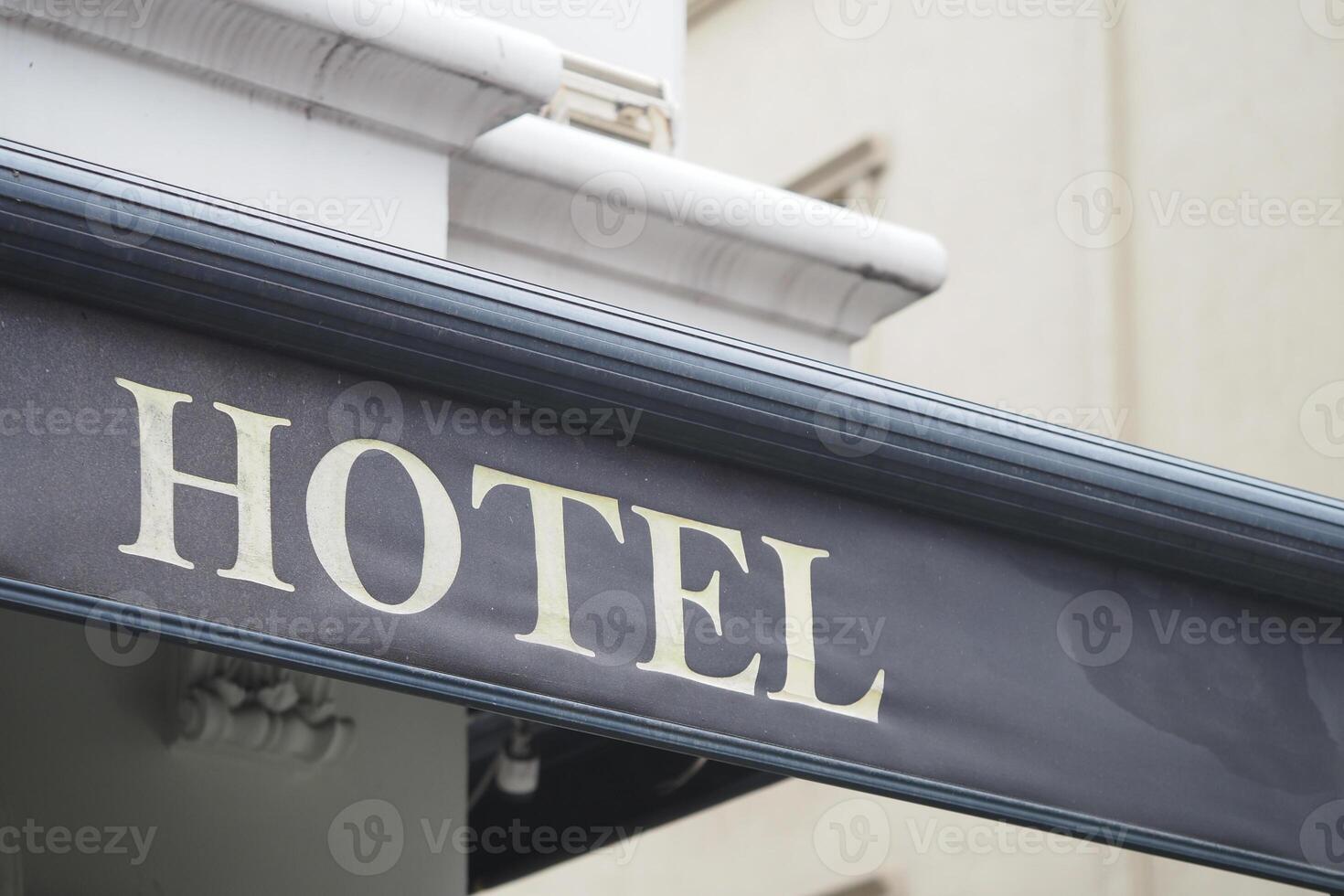 Hotel signage in urban setting during daylight hours photo