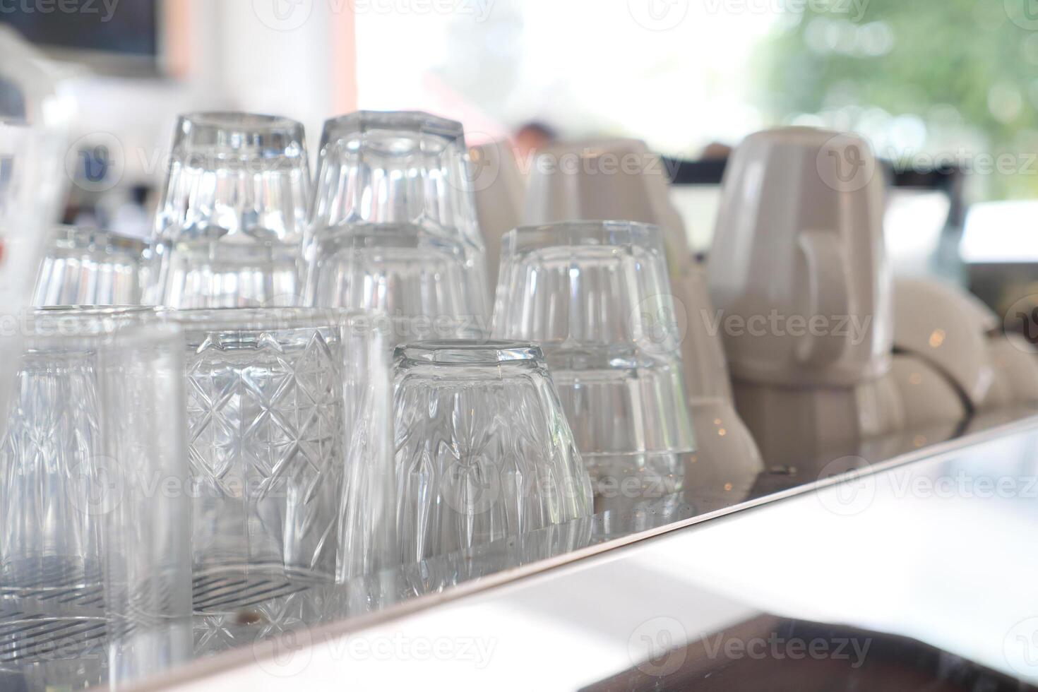 Glasses stacked on counter ready for service at cafe photo