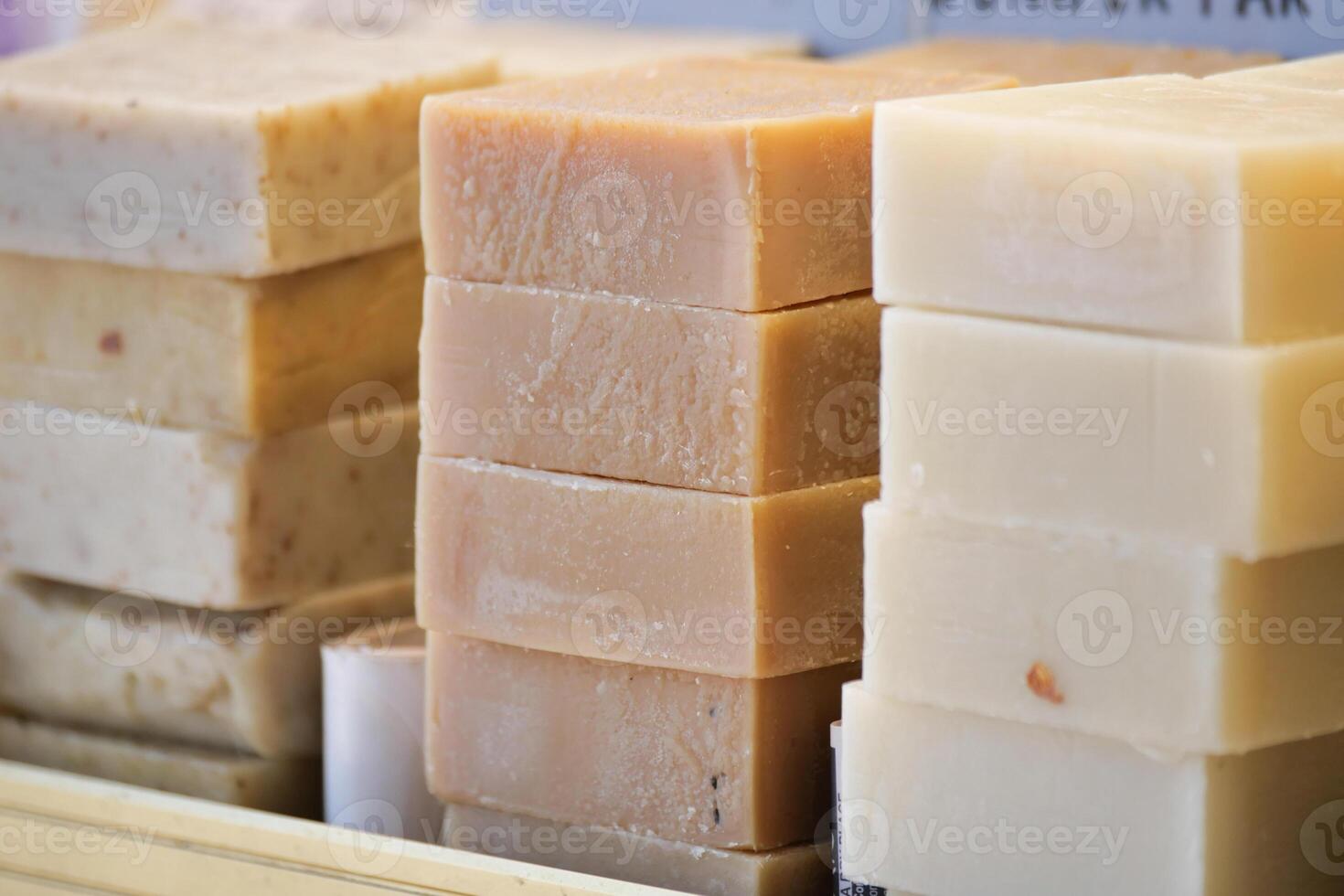 Handmade soap stacked neatly in a display at a market photo