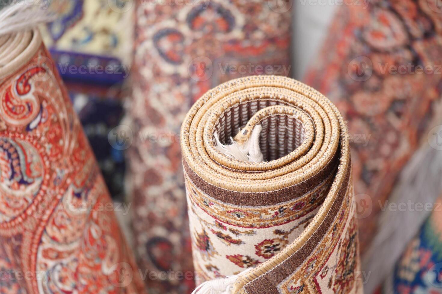 Beautifully rolled traditional rugs displayed in a market photo