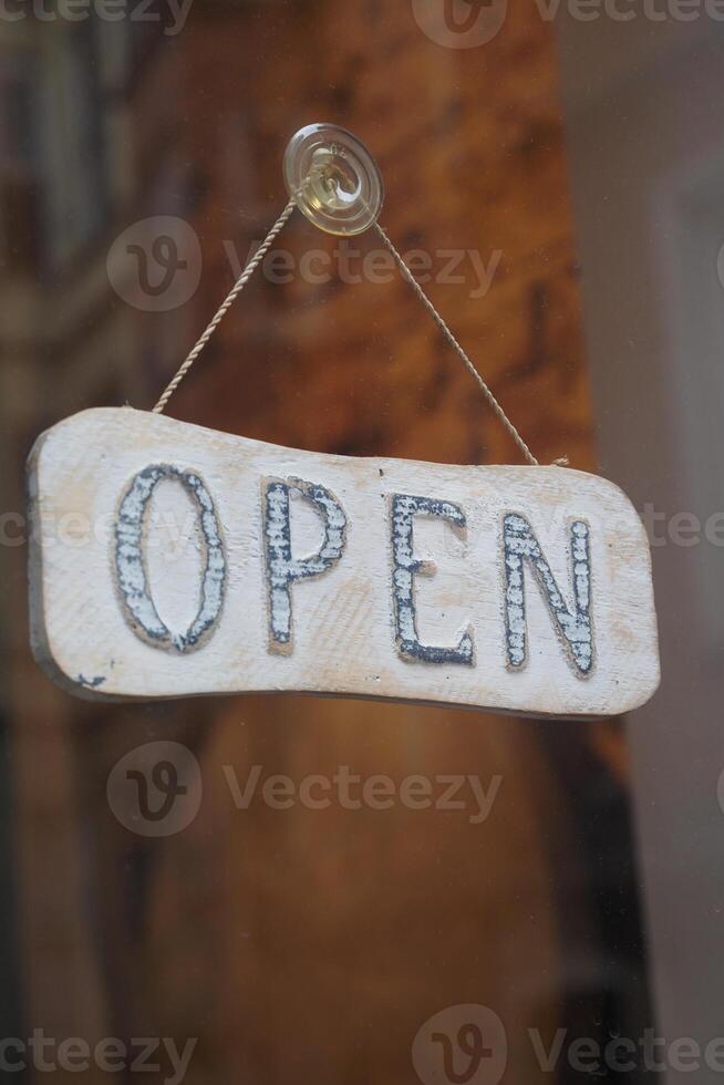Store displays open sign on business hours photo