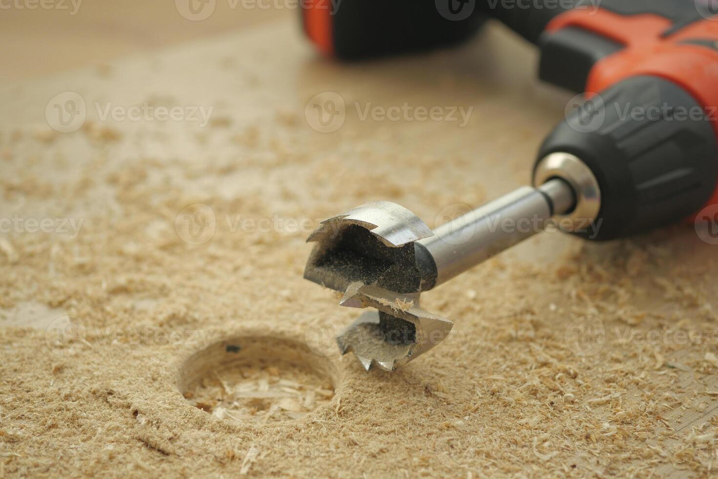 Woodworking tool is drilling into a wooden surface photo