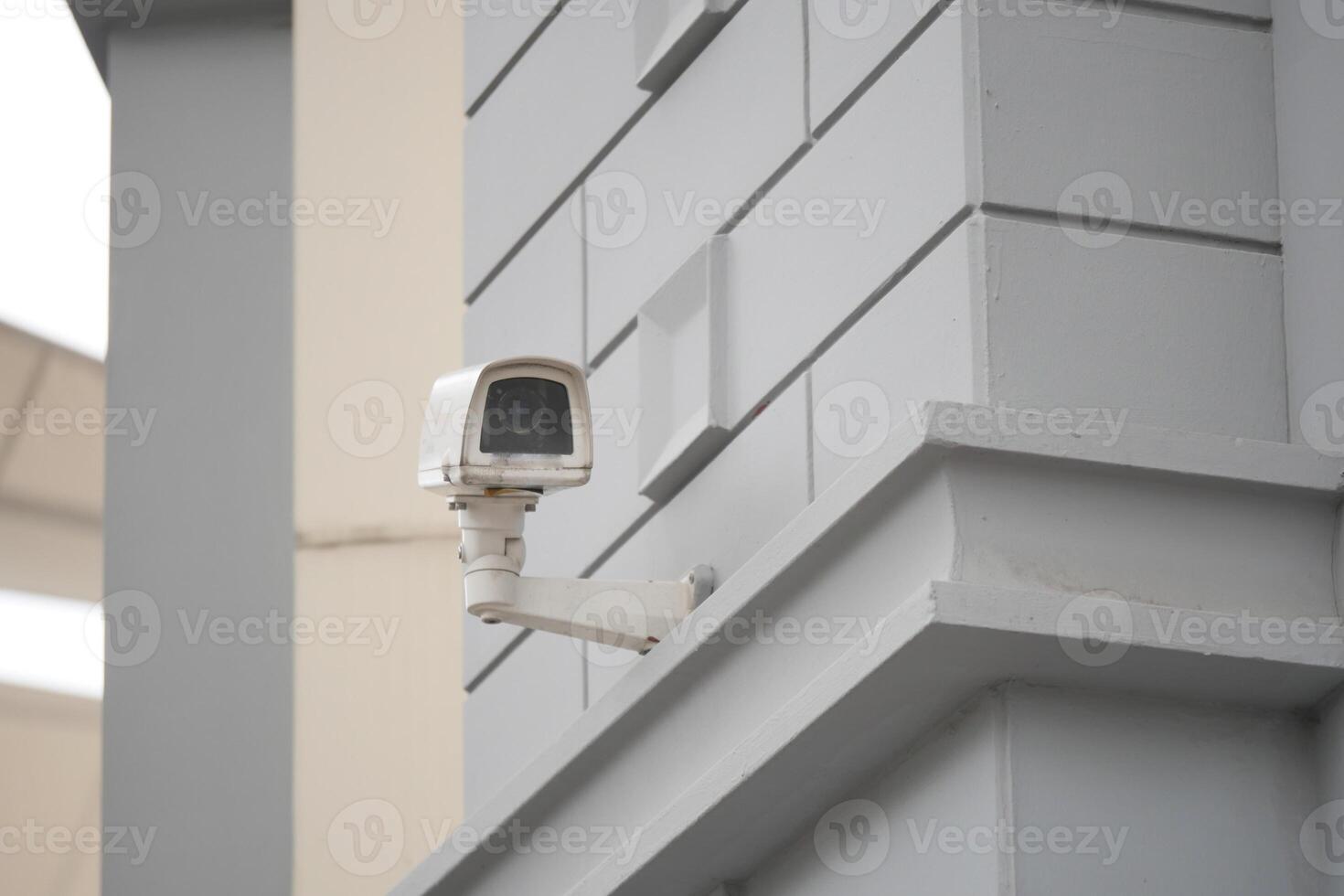 Security camera mounted on a modern building wall photo