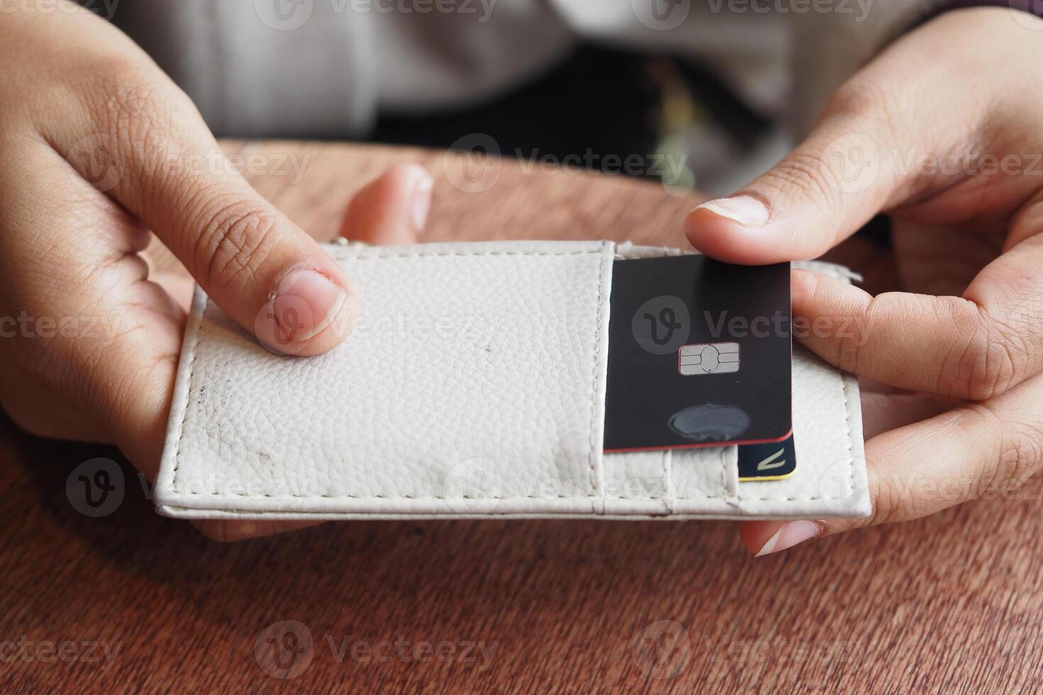 Person holding a card wallet with a bank card in hand photo