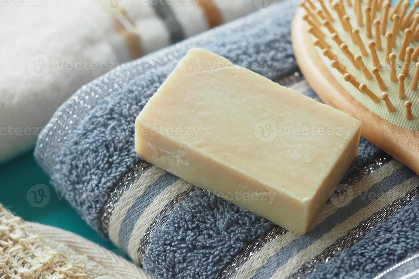 Handmade soap resting on soft towels in a spa setting photo