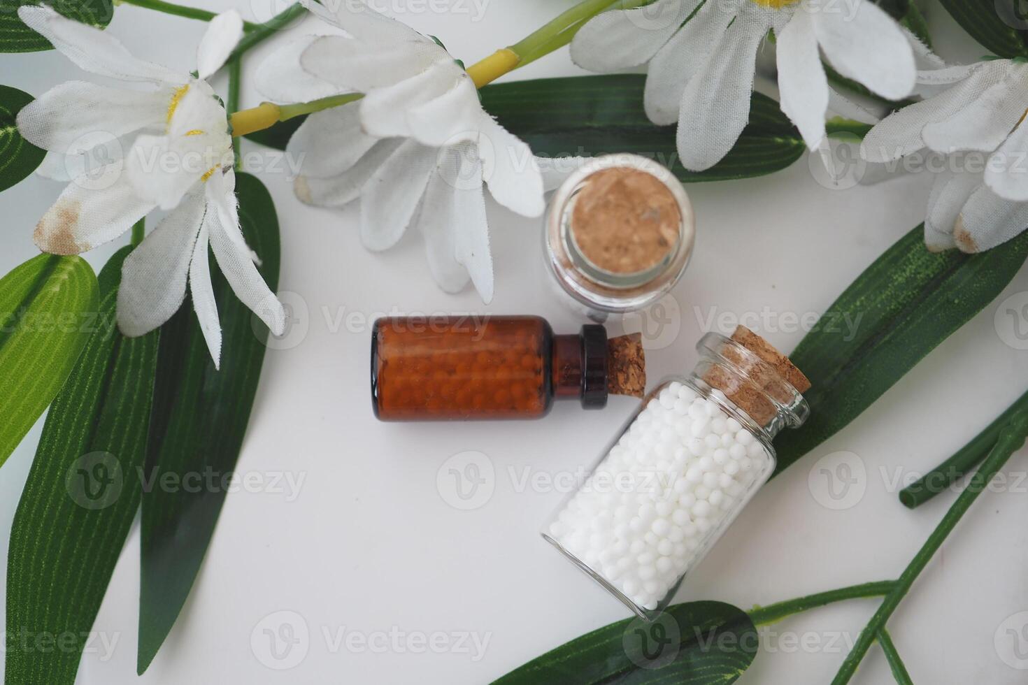 homeopathic medicine and Natural ingredients on a leafy surface photo
