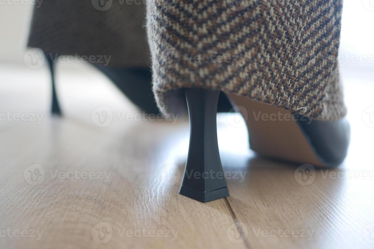 Stylish high heel shoes on wooden floor in natural light photo