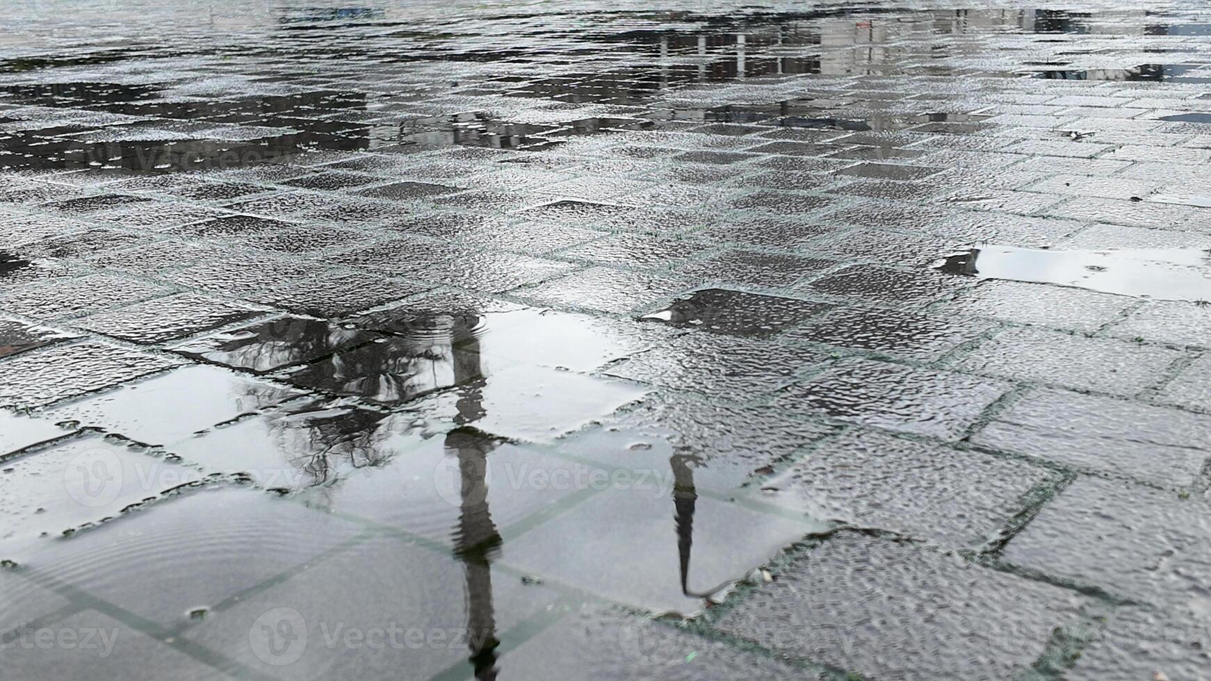 Reflections on wet pavement after a rain shower in the city photo