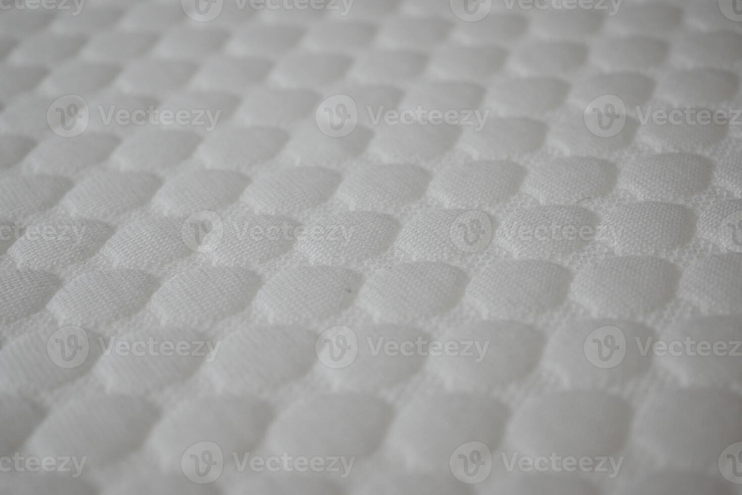 Textured surface of a soft mattress cover in closeup view photo