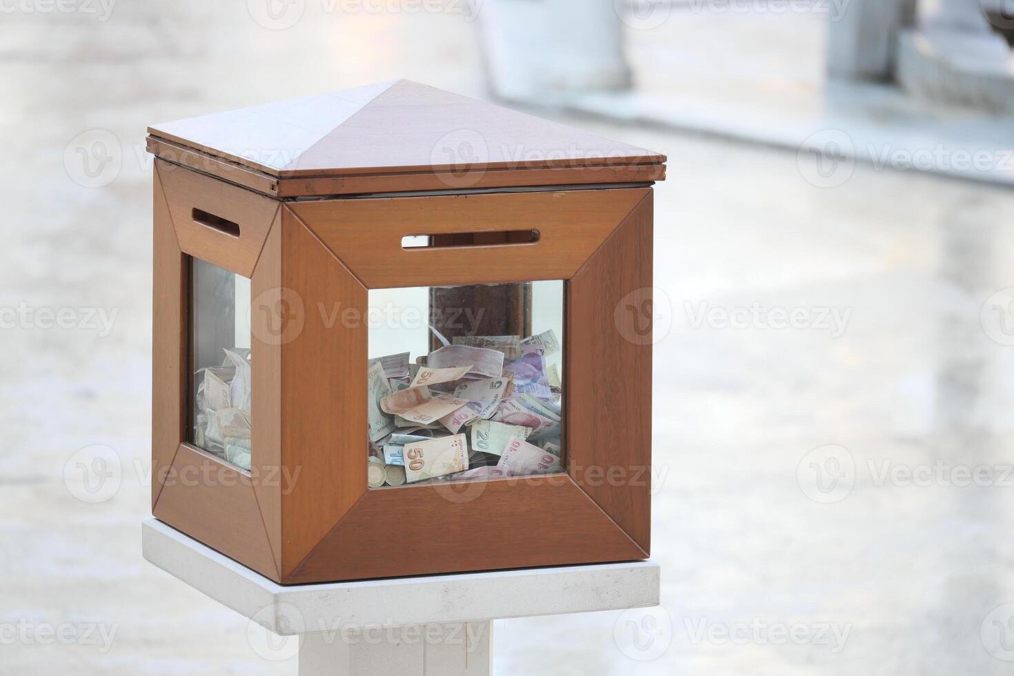 Donation box filled with cash in a public space photo