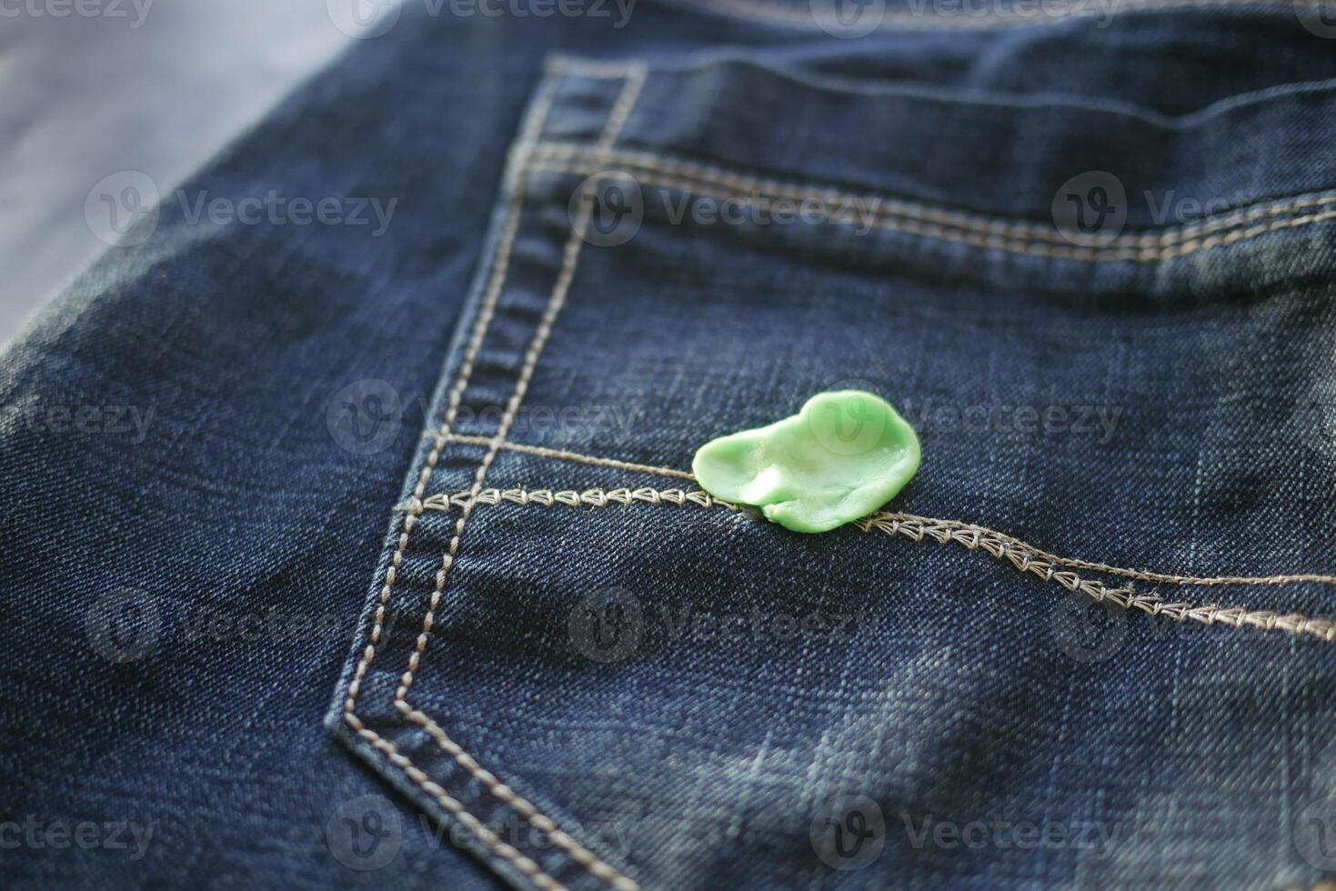 Chewing gum stuck on denim jeans pocket photo