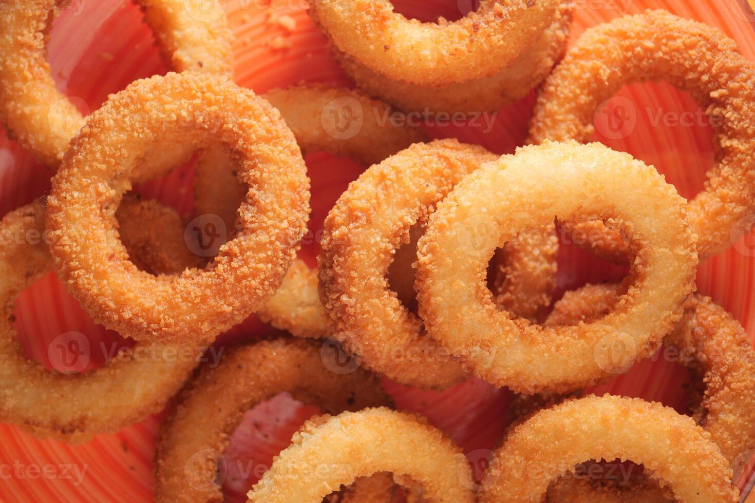 Crispy onion rings served in a vibrant bowl photo