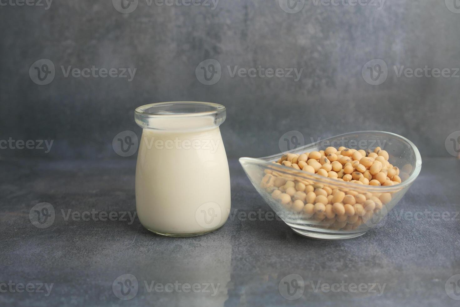 Fresh soy milk and soybeans displayed on a countertop photo