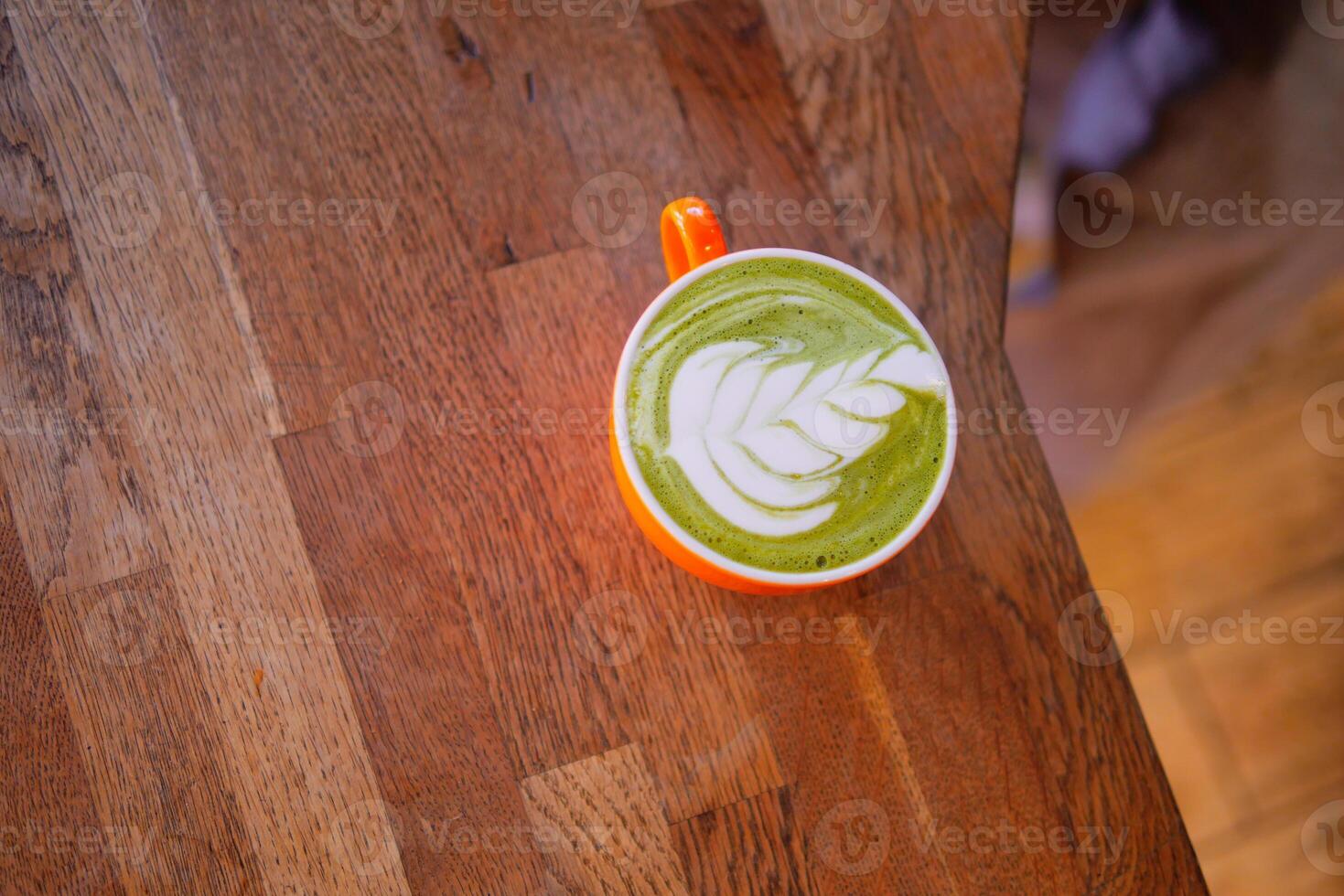Matcha latte with artistic design in a cozy cafe setting photo