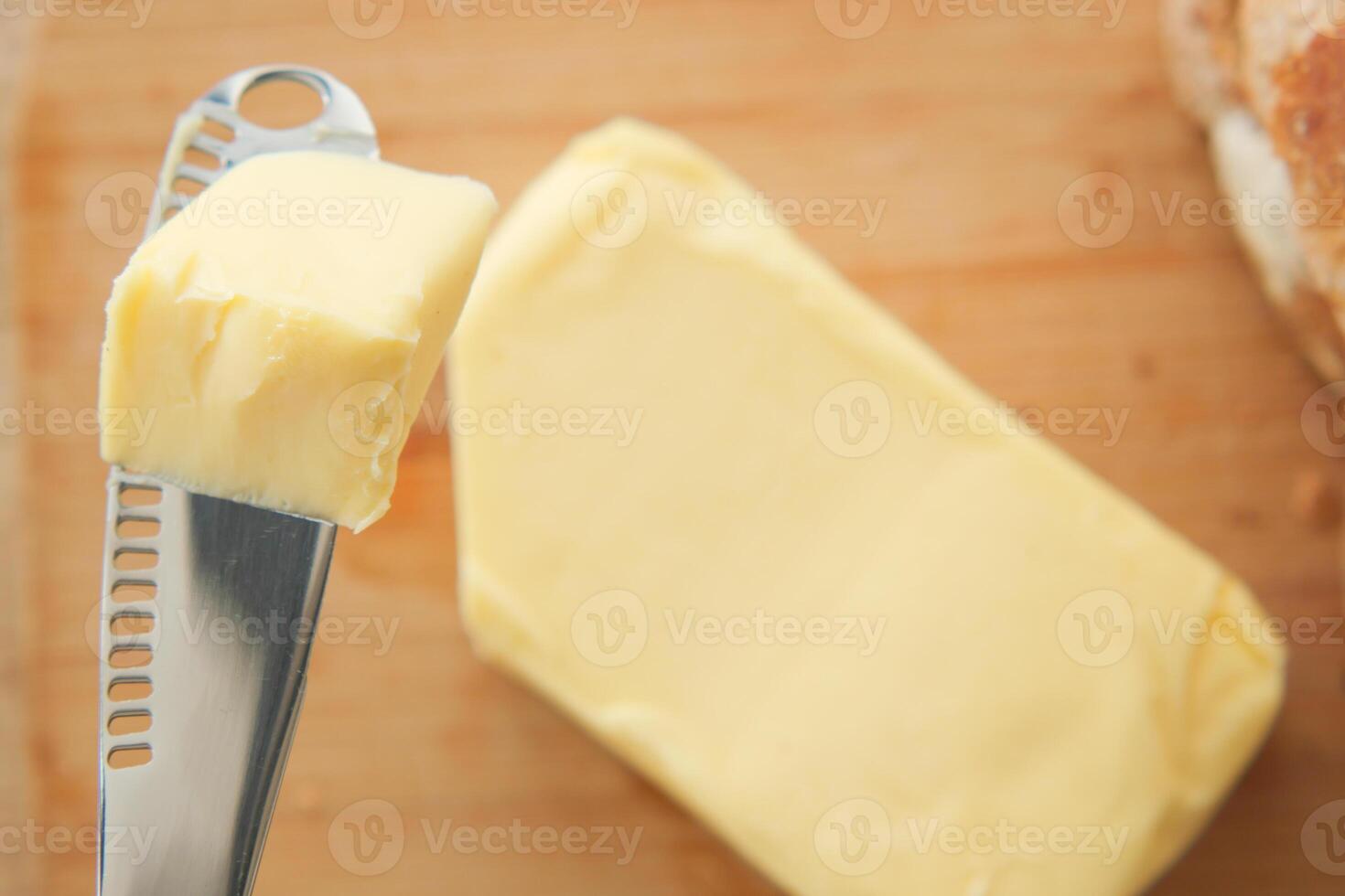 Butter on a knife ready to spread on fresh bread photo