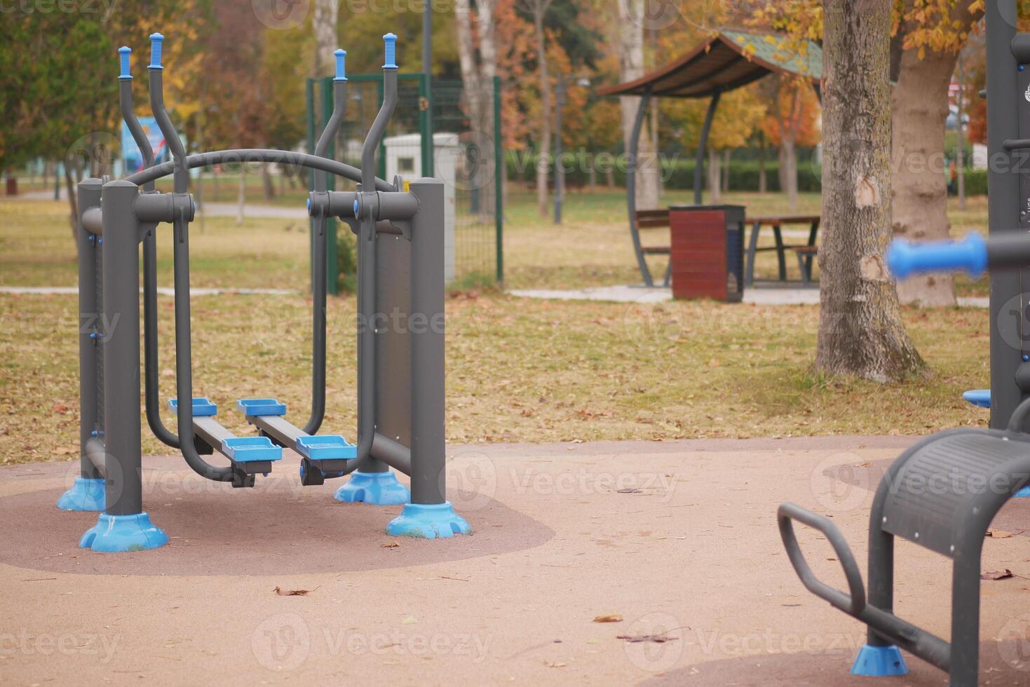 Outdoor fitness equipment in a park during autumn photo