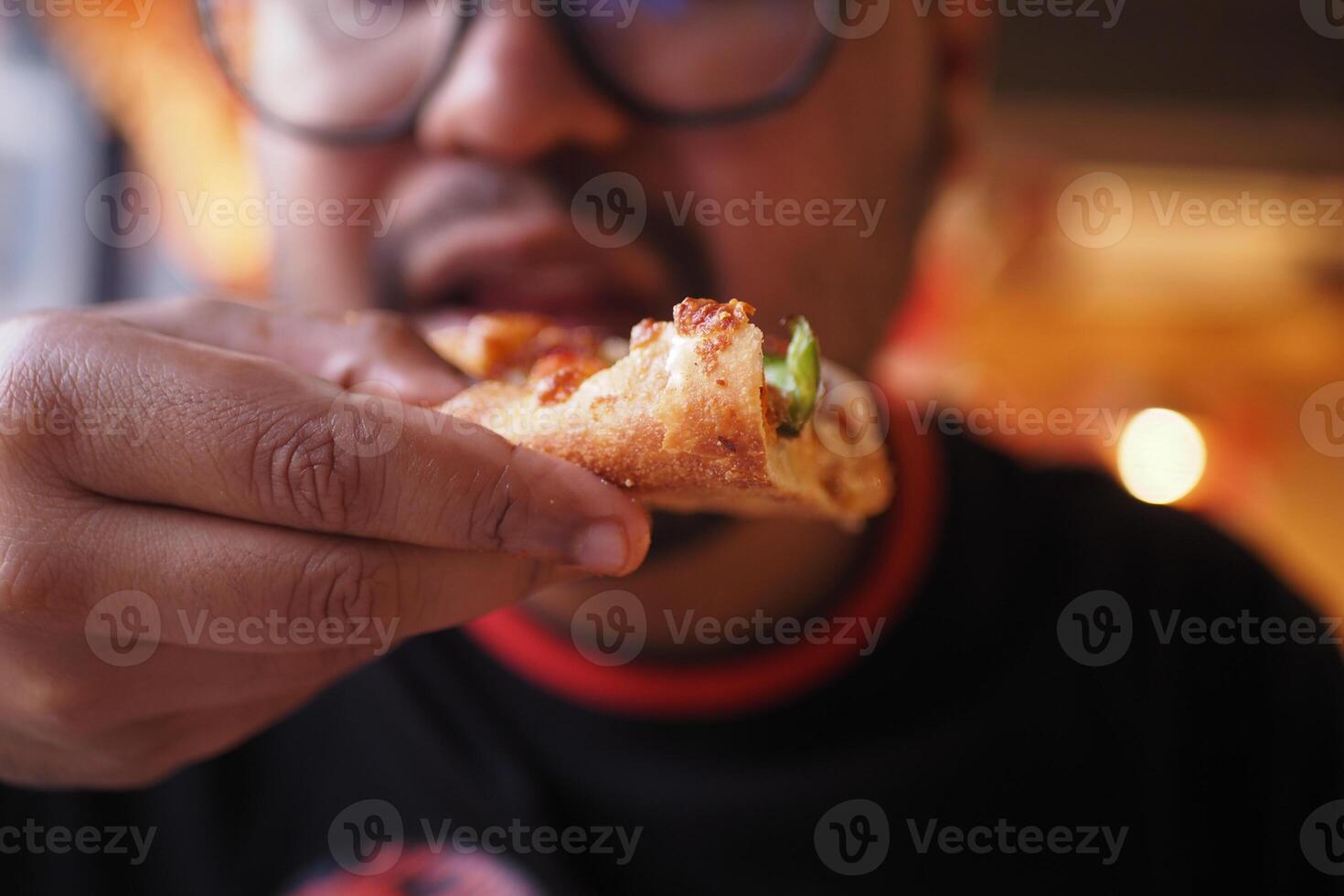 Enjoying a slice of pizza at a cozy restaurant photo