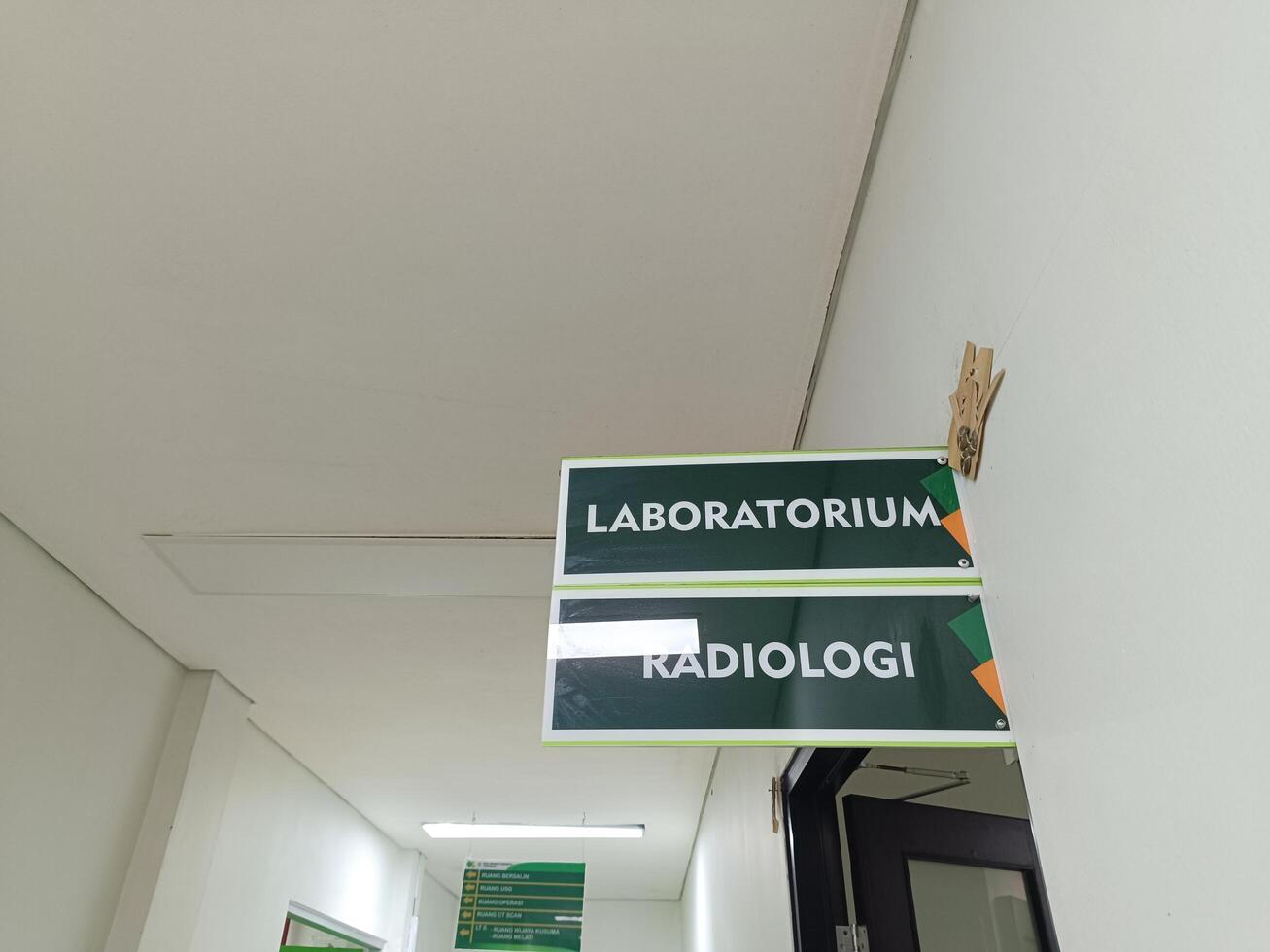 A signpost leading to the Laboratory and Radiology room at a hospital in Bali. photo