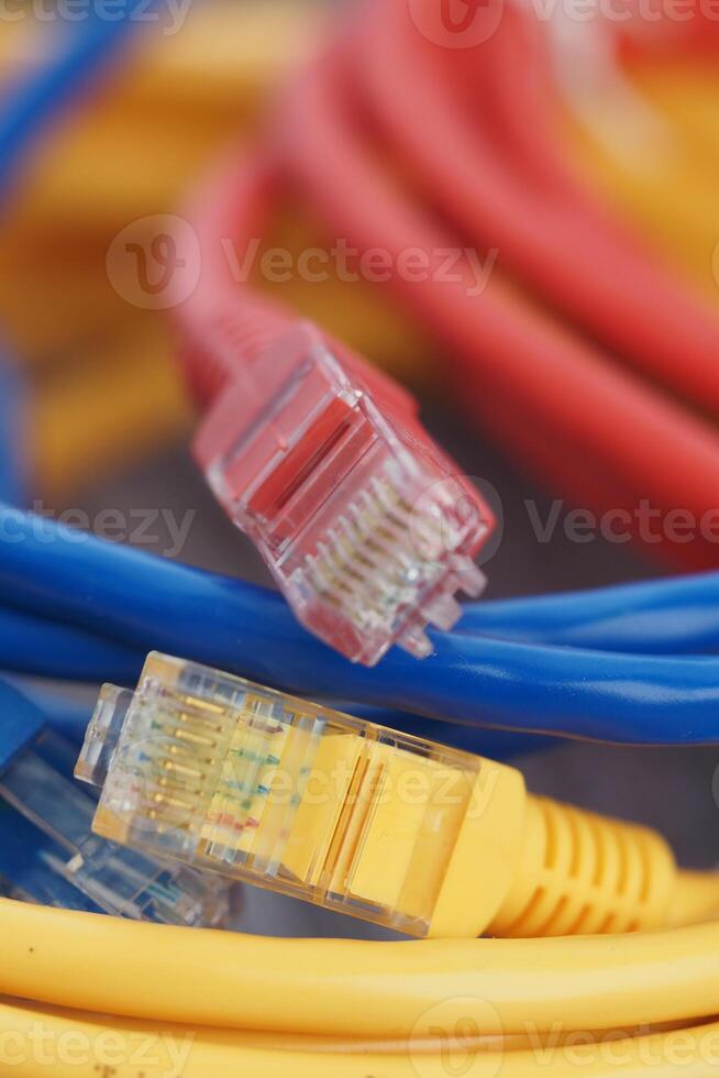 Colorful network cables intertwined on a surface photo
