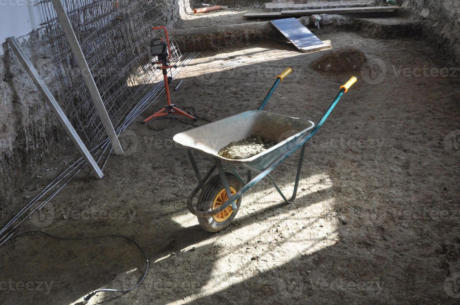 wheel barrow in building site aka construction site photo