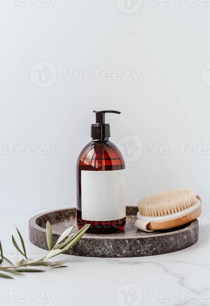 Mockup for bathing products in the bathroom - shower gel, liquid soap, anti-cellulite care with wood brush beside on white background photo