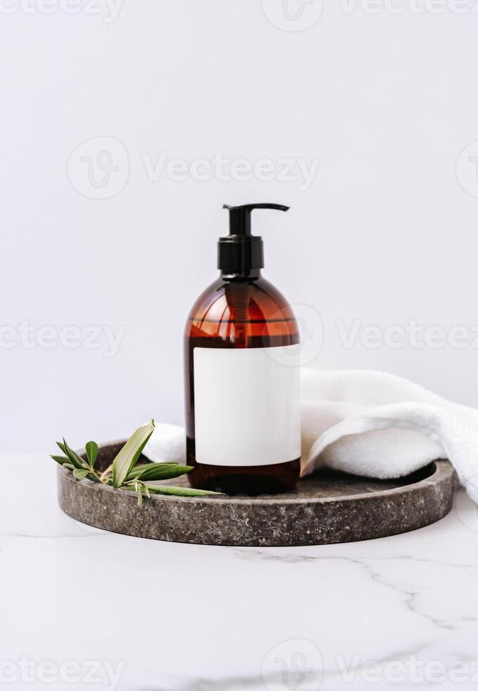Mockup for bathing products in the bathroom, spa shampoo, shower gel, liquid soap with a towel beside on white background photo