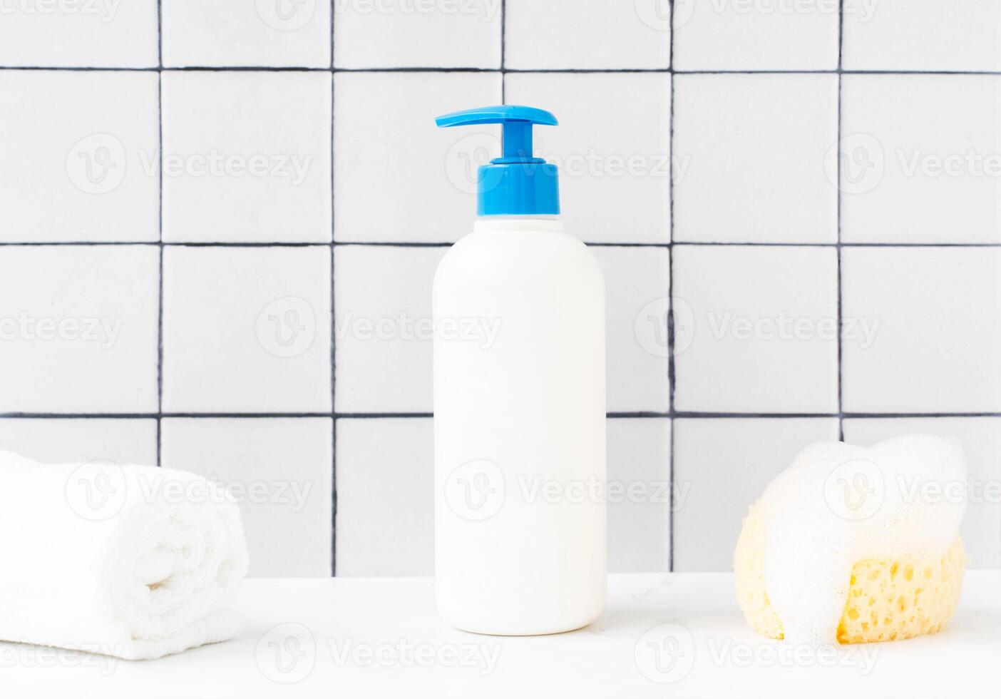White plastic bottle with blue cap mockup for bathing products in bathroom photo