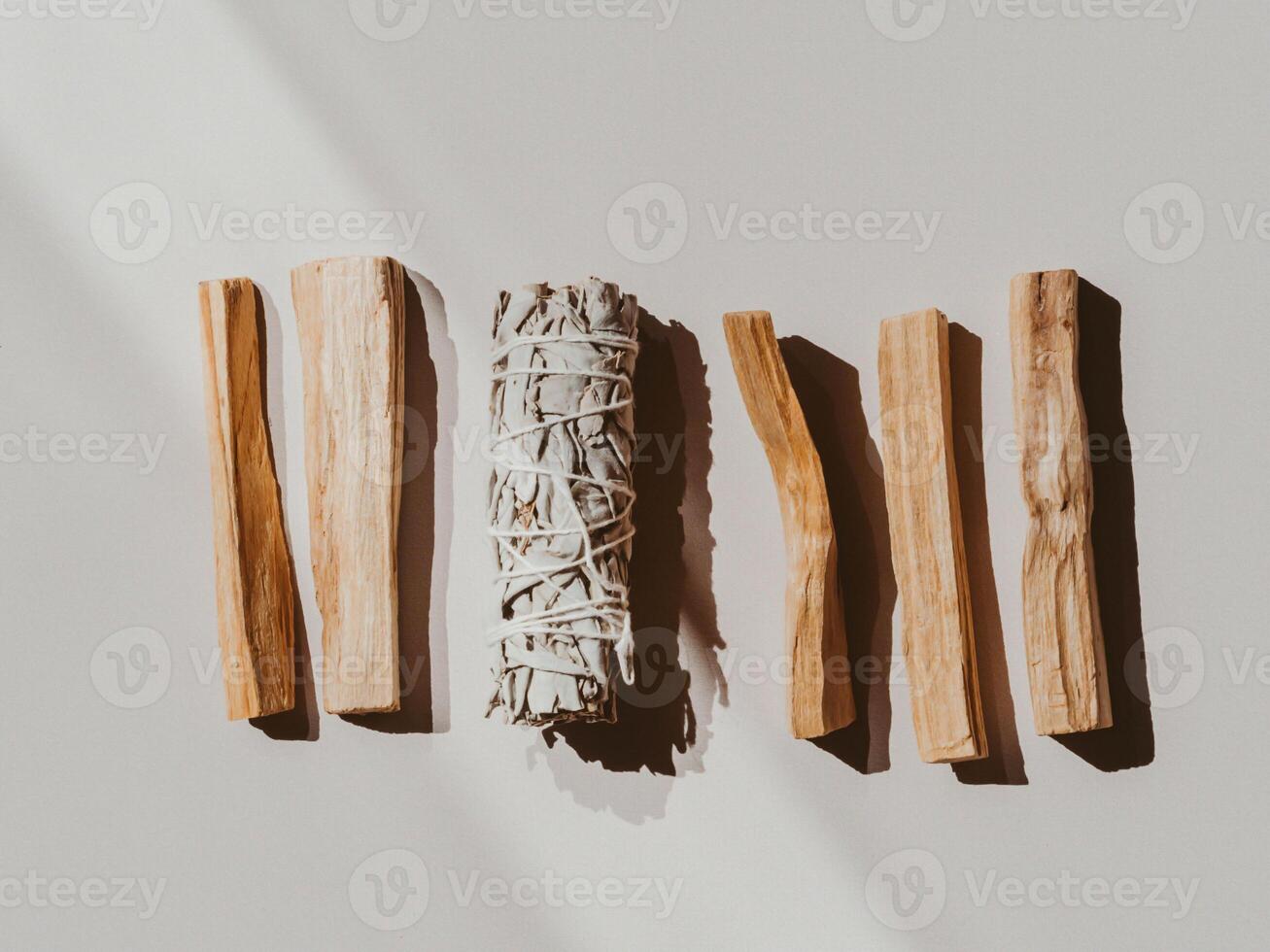 White sage and Palo Santo on a light beige background photo