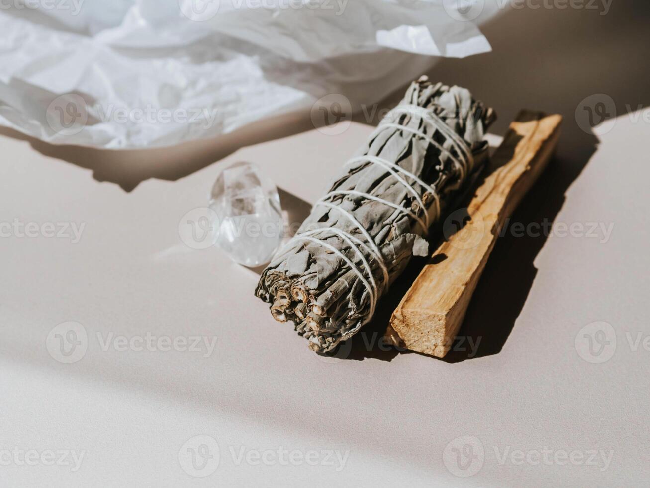 White sage and Palo Santo on a light beige background. A set of incense for fumigation photo