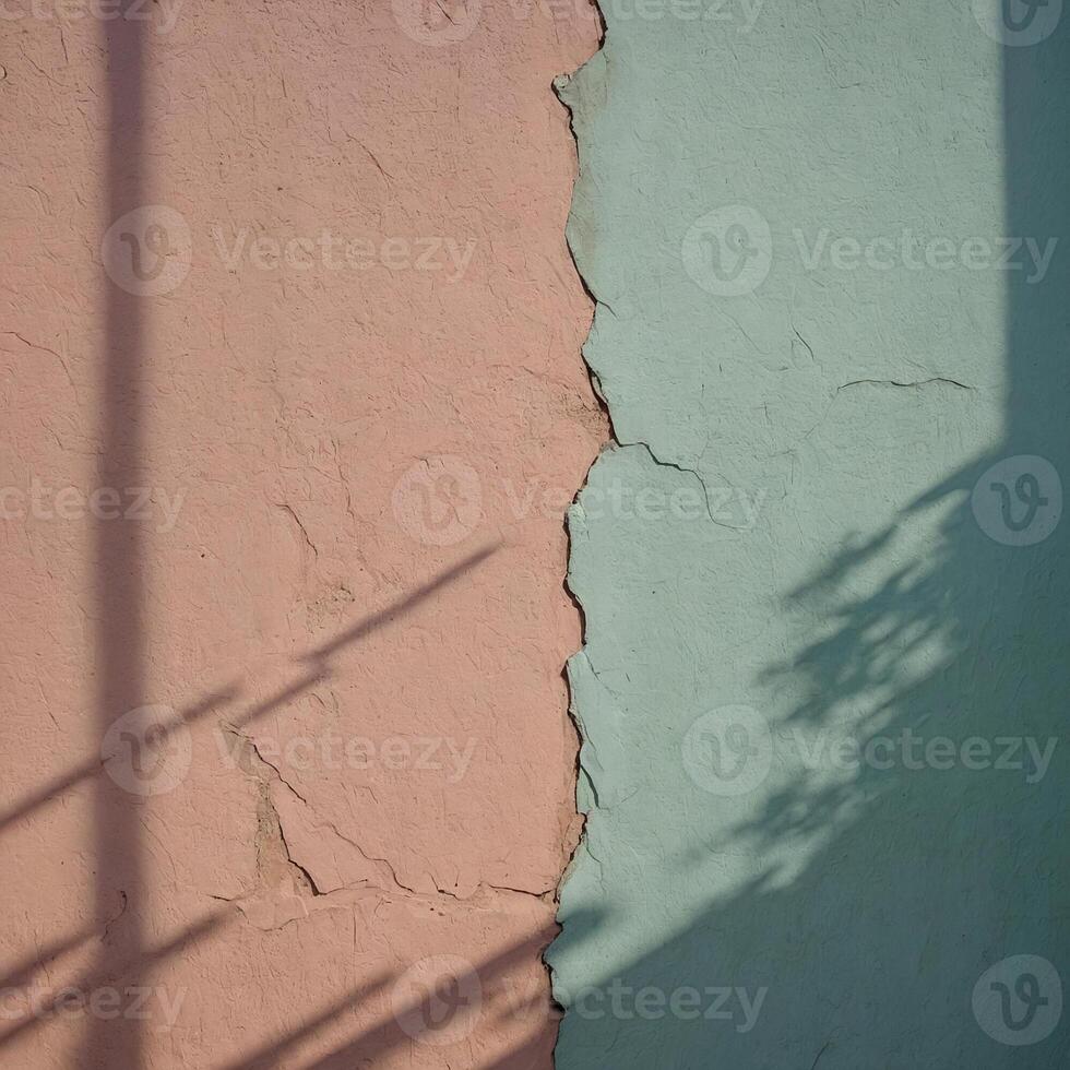 A beautifully painted wall in pink and green shades with a shadow cast upon it photo