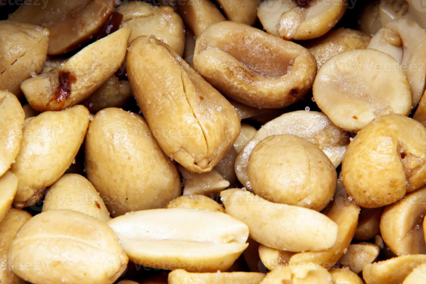Close-up of salted roasted peanuts in macro view photo