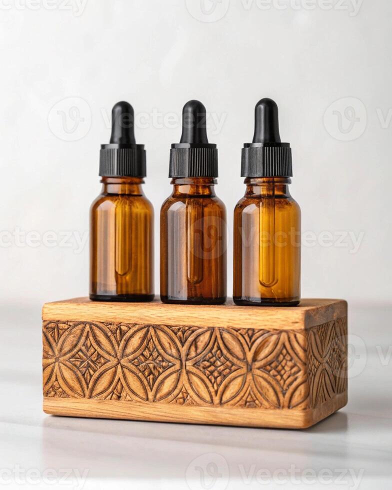 Three bottles of essential oils on a wooden stand photo