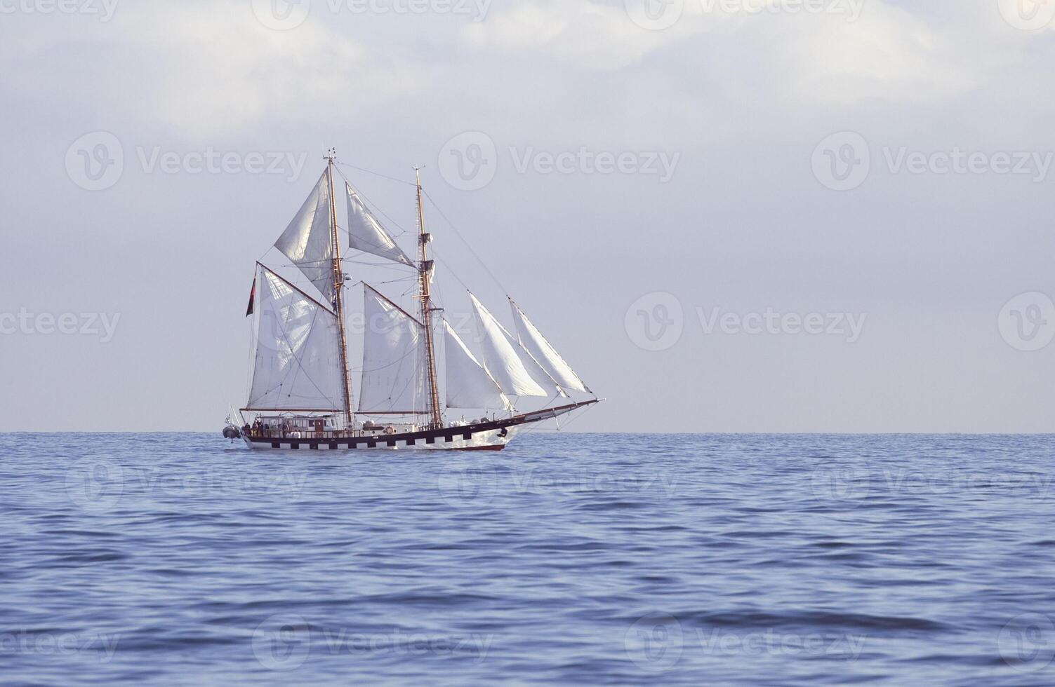 Tall ship in full sail in the sea photo
